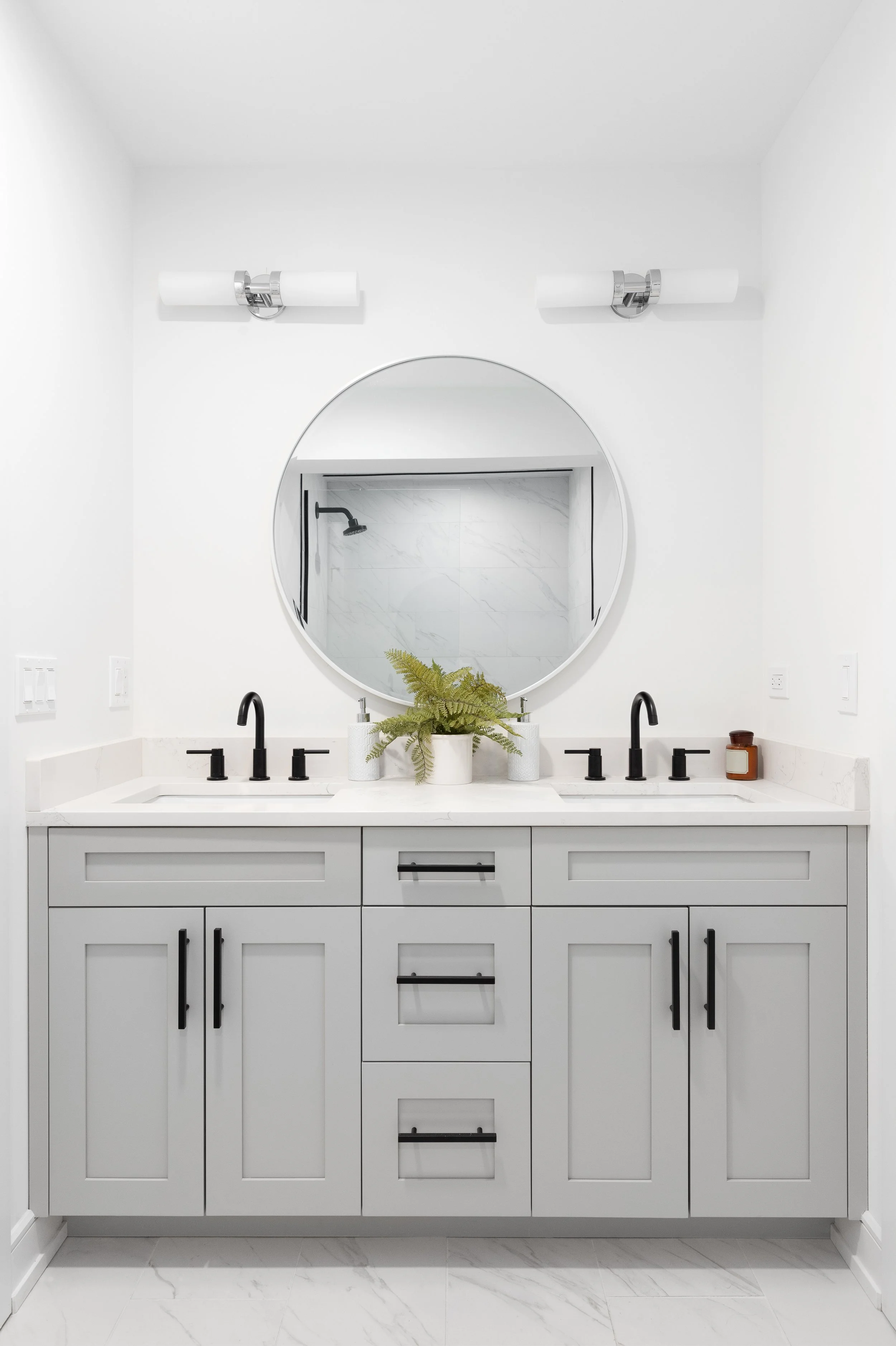 Modern bathroom vanity with gray cabinets and marble countertop — Toronto