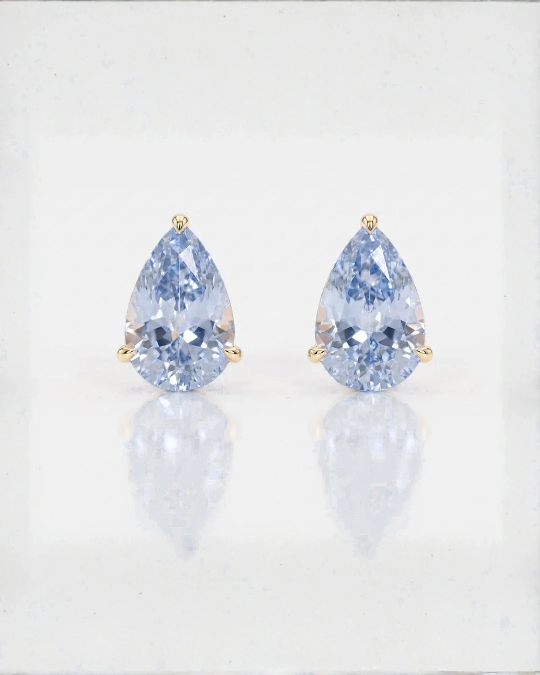 Blue sapphire pear earrings in 14k gold