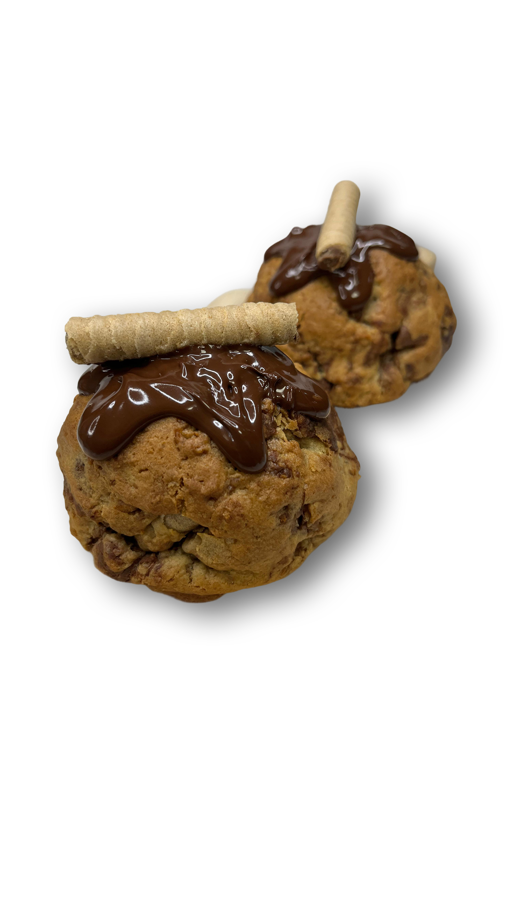 Dos bollos de chocolate con cobertura de chocolate, adornados con galletas María y una roca de chocolate en la parte superior, sobre fondo negro.