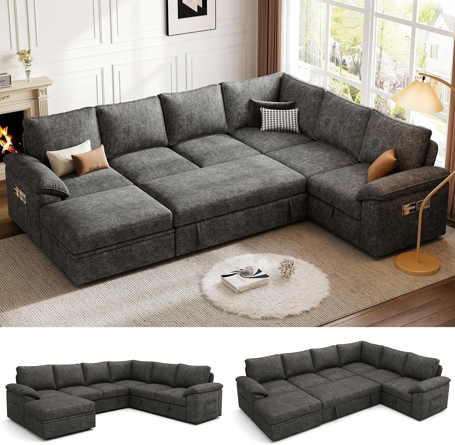 A living room with a large, dark gray sectional sofa with various pillows, a rug, a coffee table with books and decorative objects, a window with curtains, and a very small fireplace with a vase of flowers on the mantle.