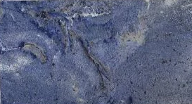 Close-up of a textured, gray stone or concrete surface with some darker lines and irregularities.