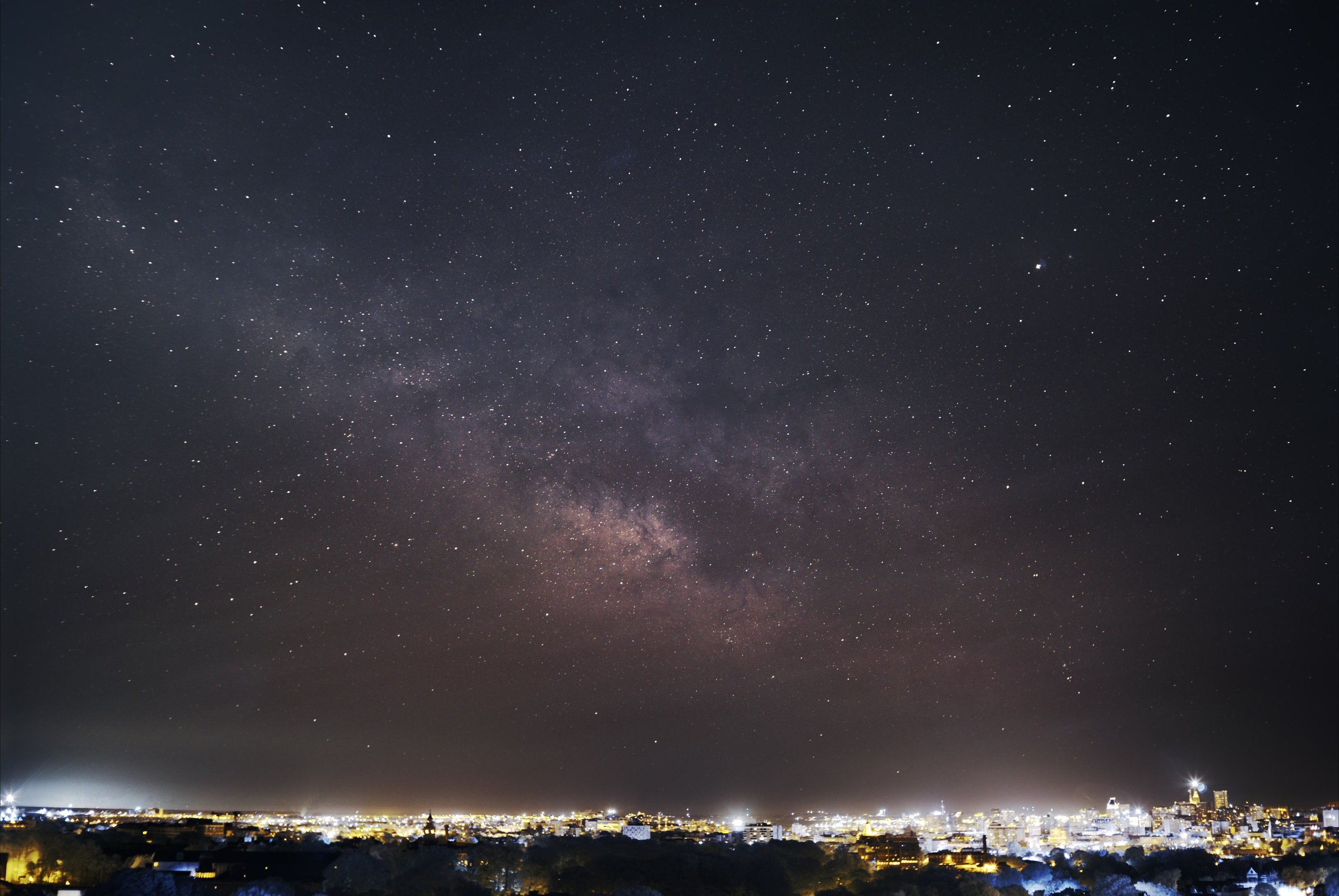 An infrared image of the night sky over Baltimore. The infrared light cuts through the light pollution, revealing the milky way.