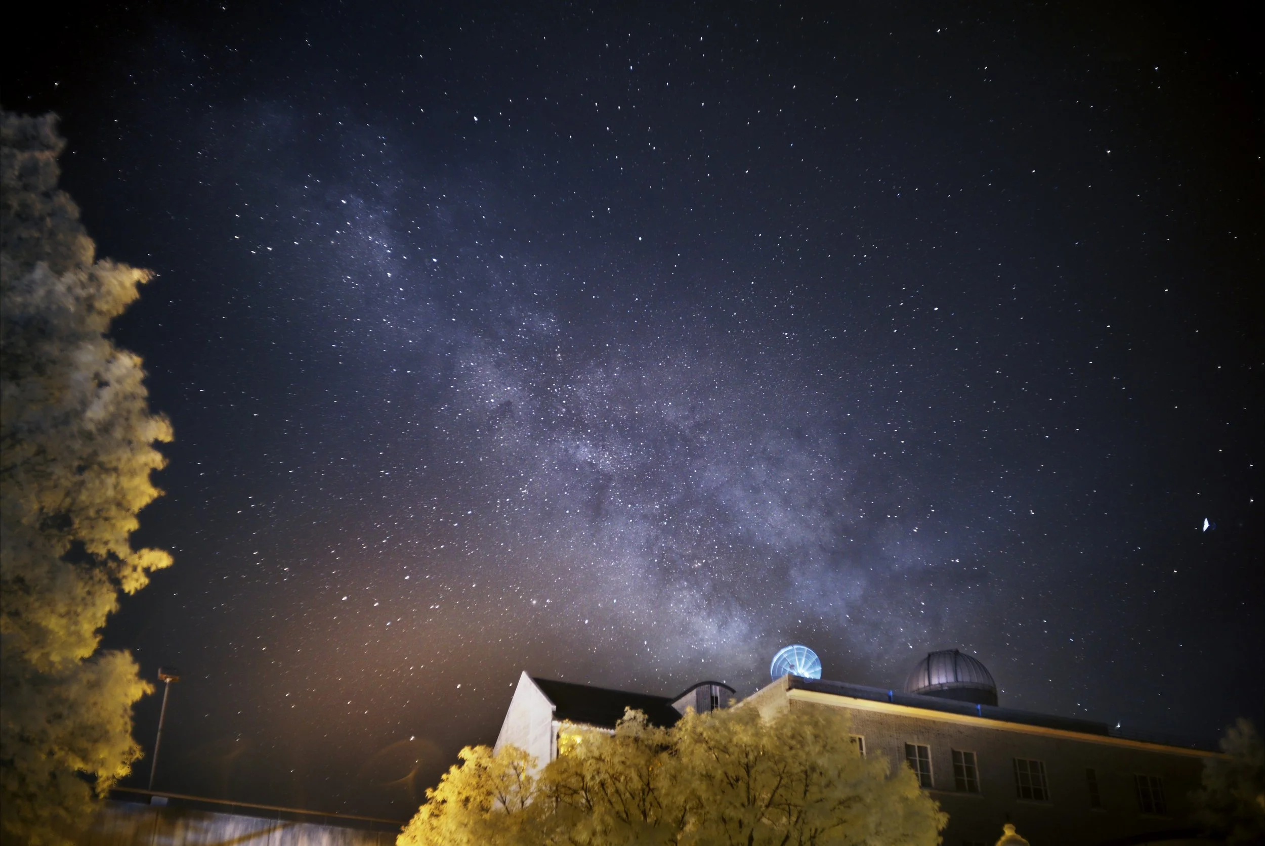 An infrared image of the milky way rising behind the observatory at Johns Hopkins in Baltimore, Maryland