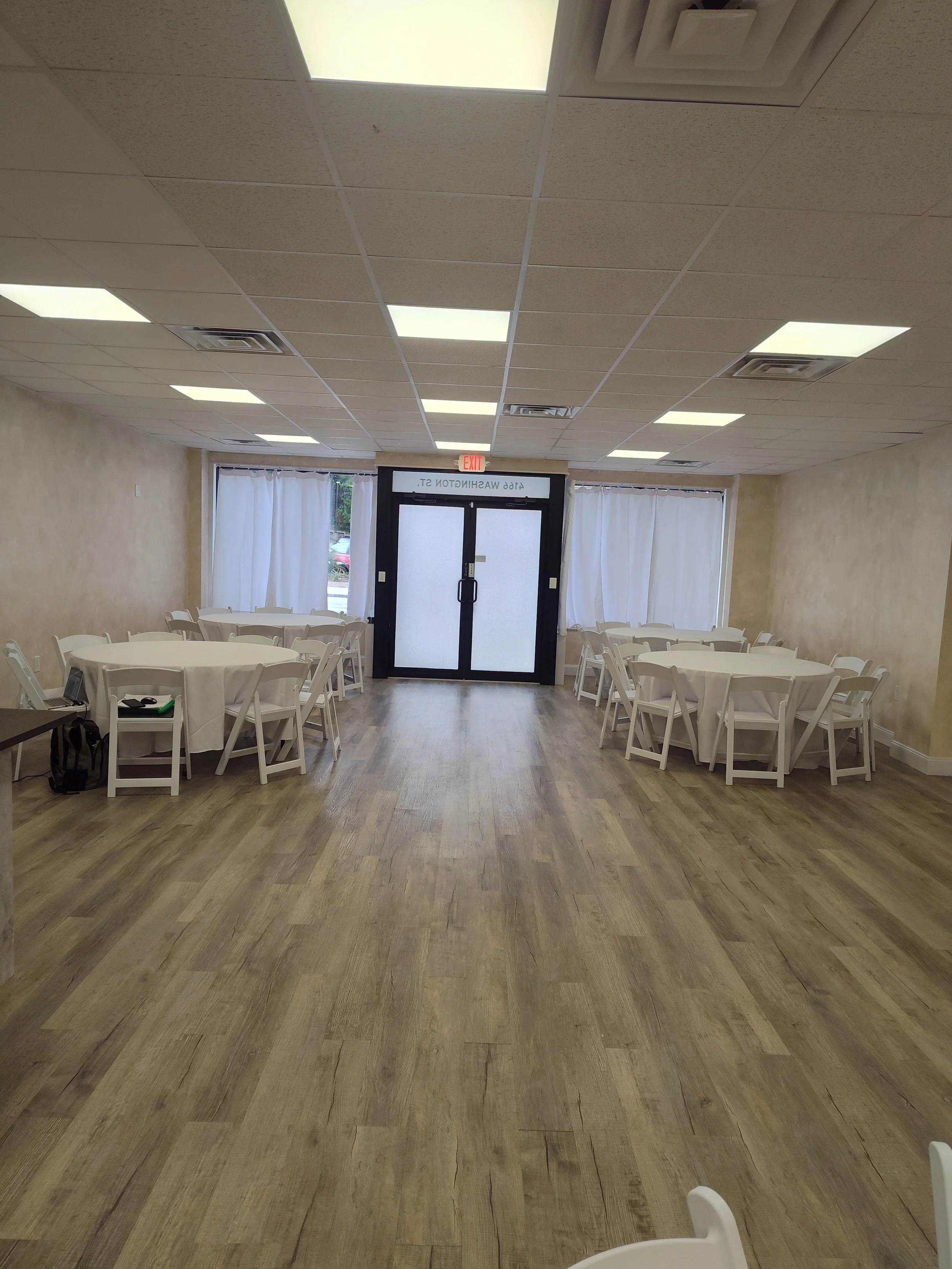 overview of venue Venue with round tables, white linens and white garden chairs