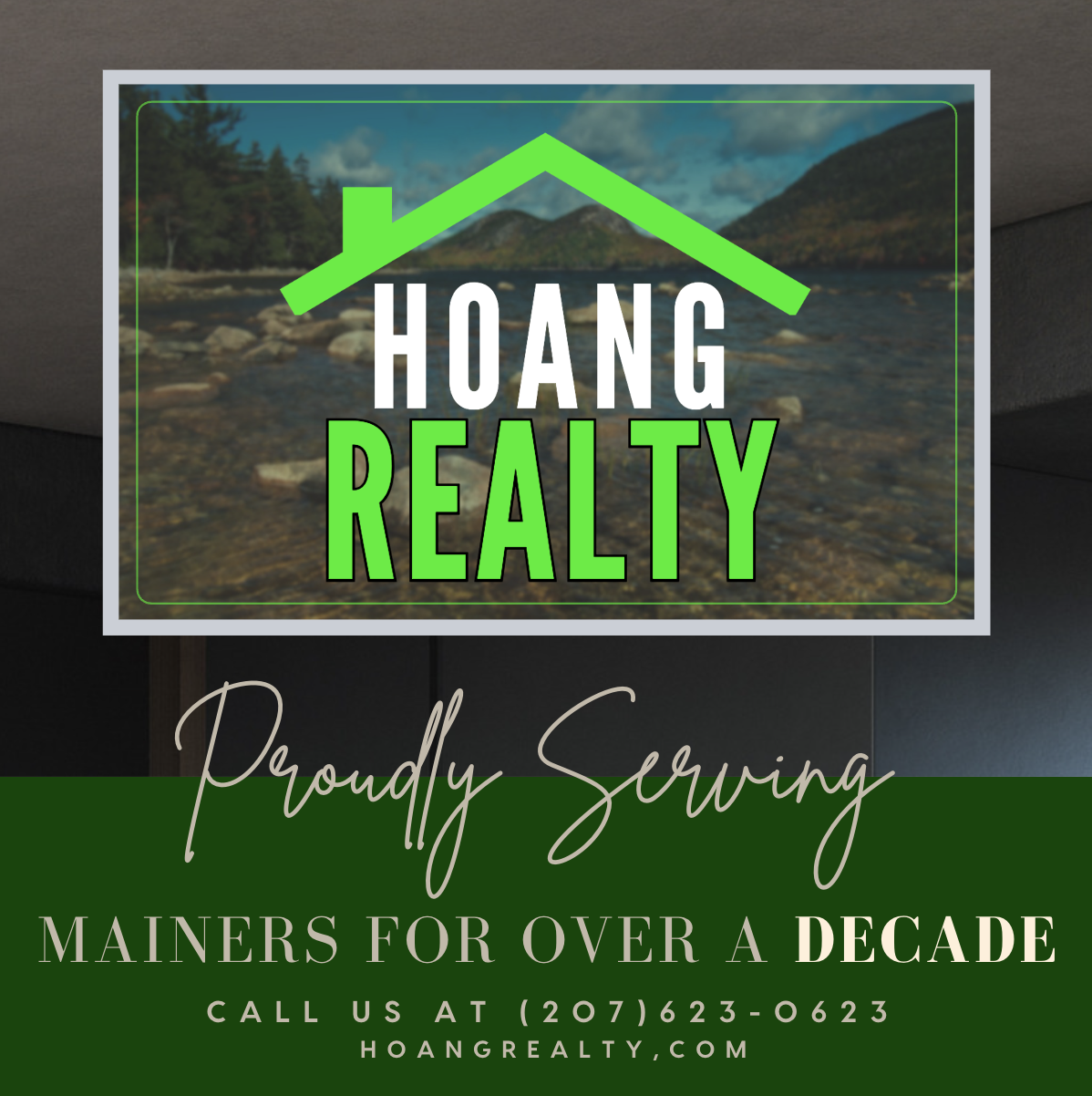 A real estate company's sign with mountain and river background, displaying the words 'Hoang Realty' in bold white and green letters, with a green house roof graphic above.