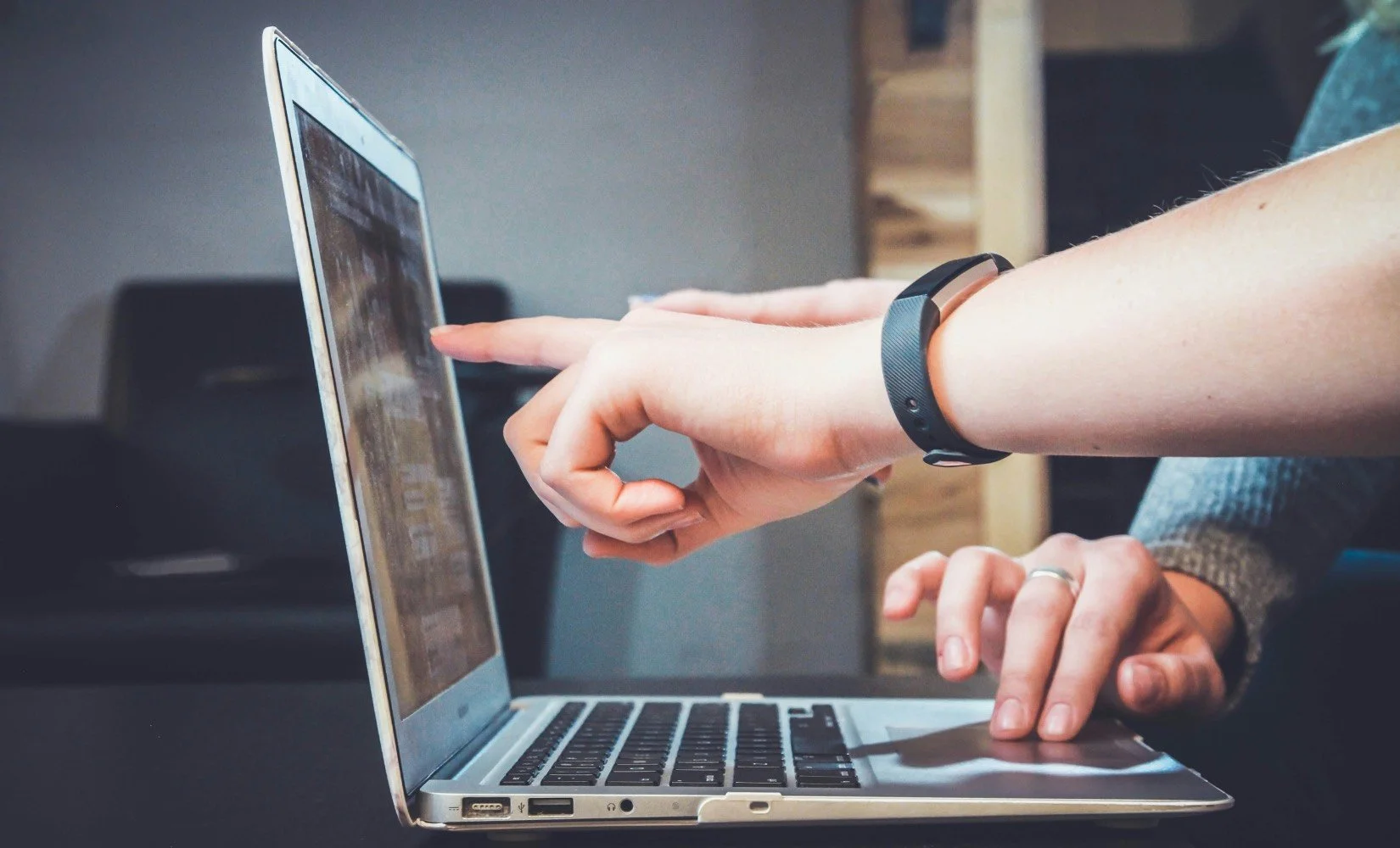 Realtors marketing through social media on laptop