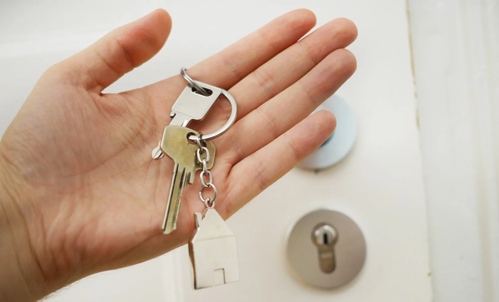 Hand holding keys to new property
