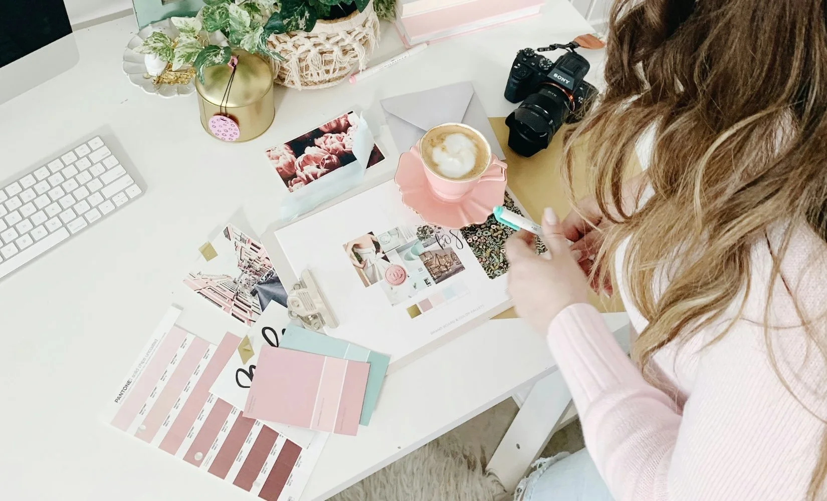 Woman plans brand image with brand guideline kit for color palettes, typography, and moodboard