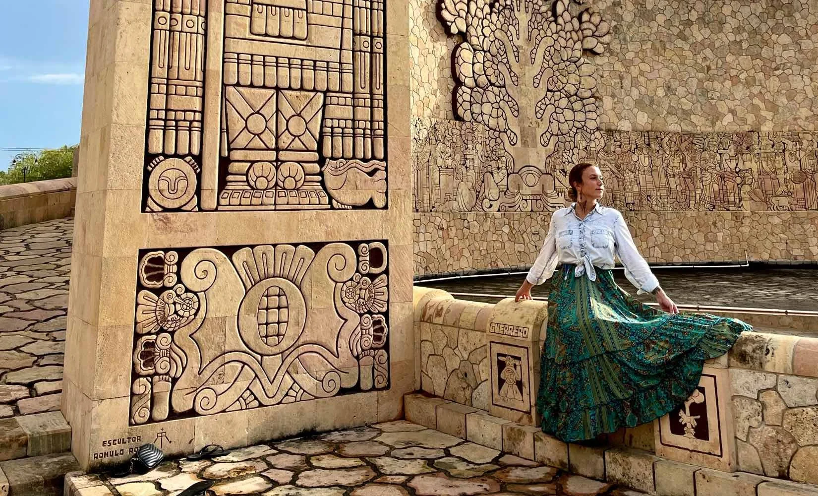 Posing at the Monumento a la Patria in a long dress while a tourist takes my photo for me