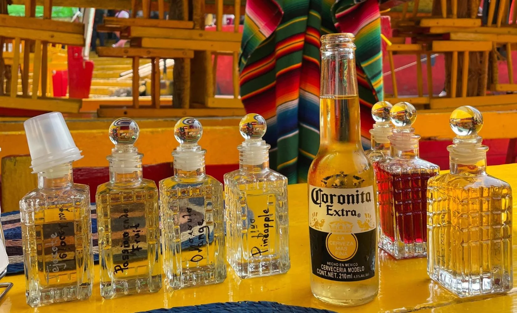Tasting 18 different flavors of mezcals on a colorful trajinera (boat) on the canals of Xochimilco, Mexico City