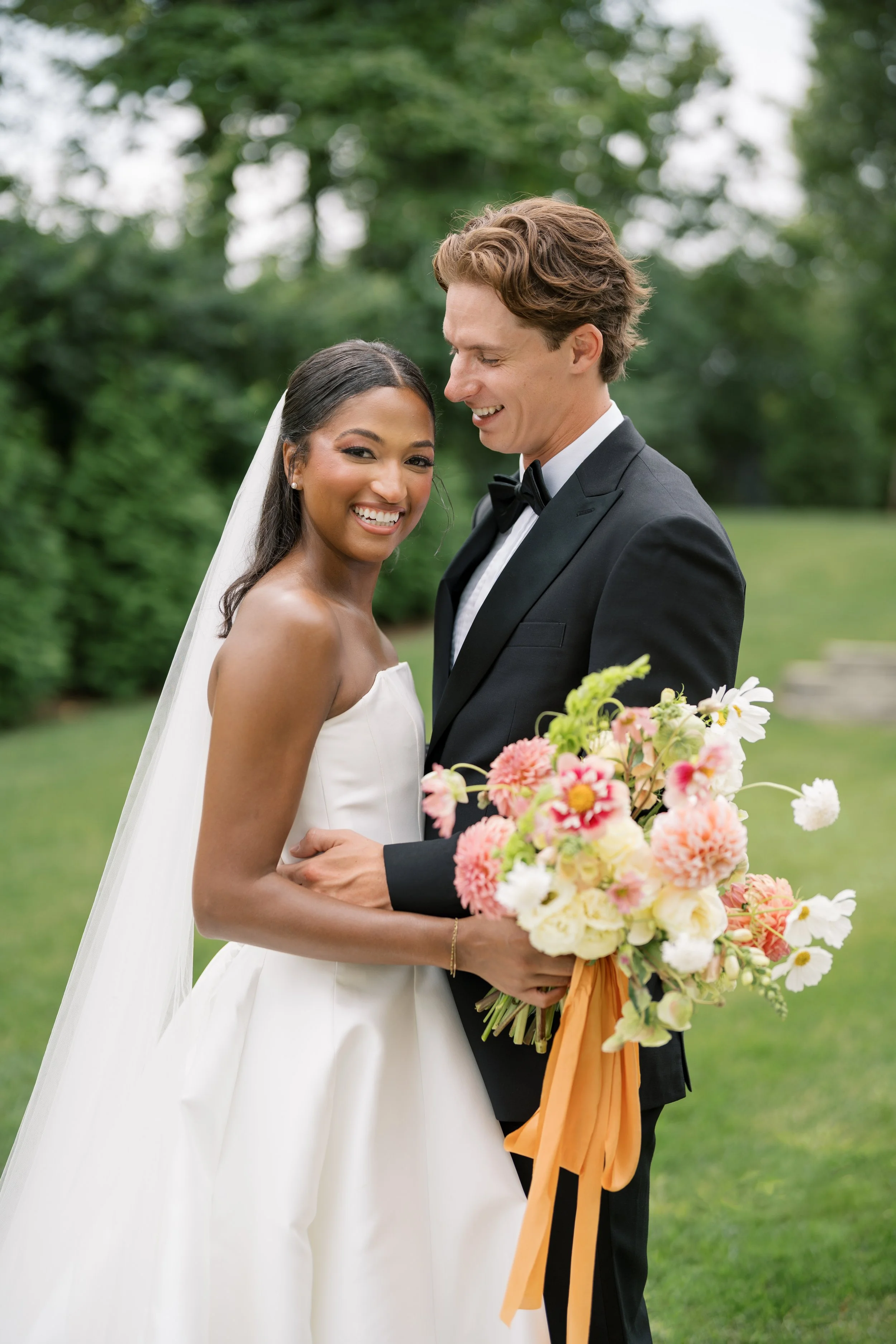 Bride and groom with colorful floral bouquet at The Palomar in Cincinnati