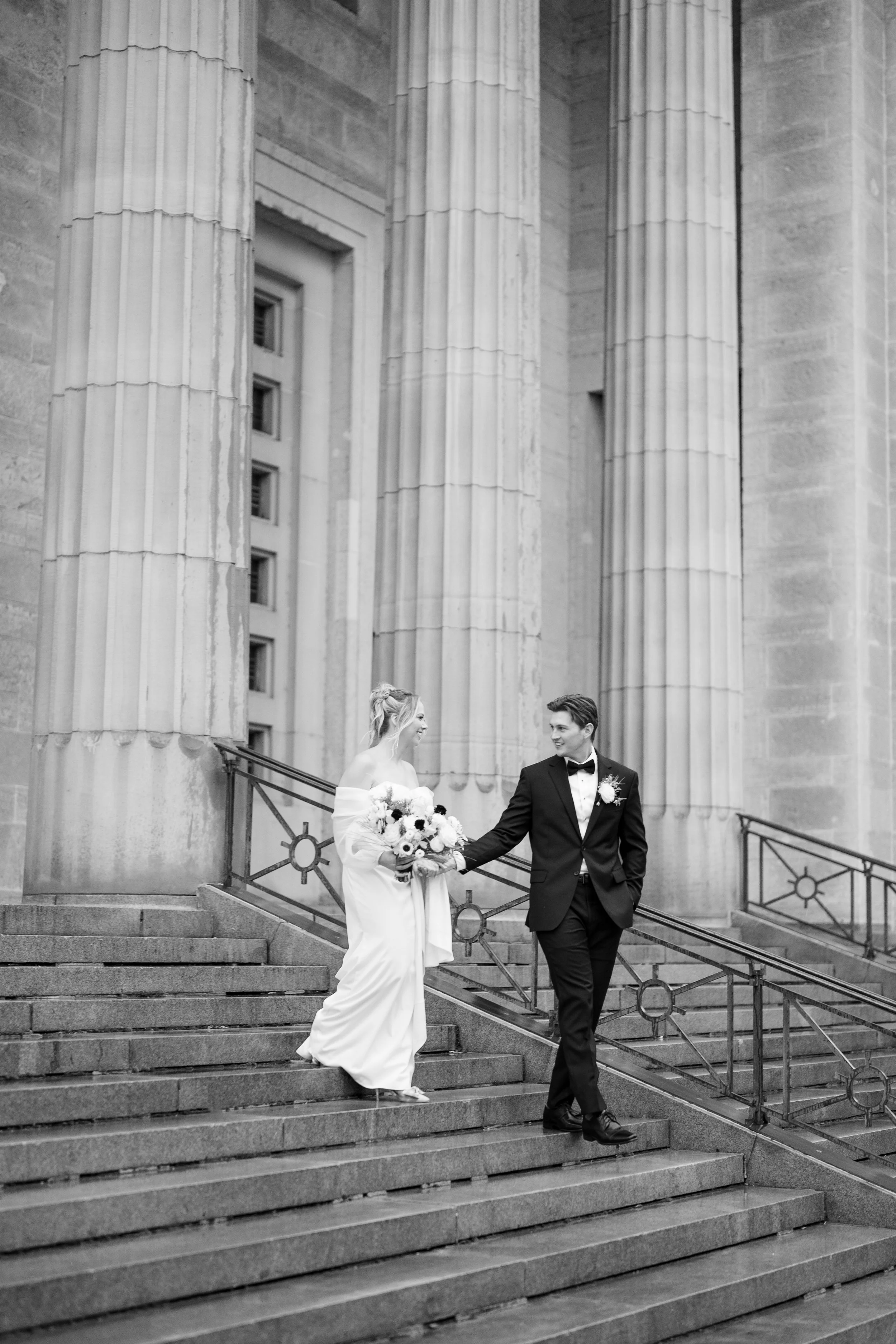 Bride and groom embracing during an evening wedding portrait in downtown Cincinnati.
