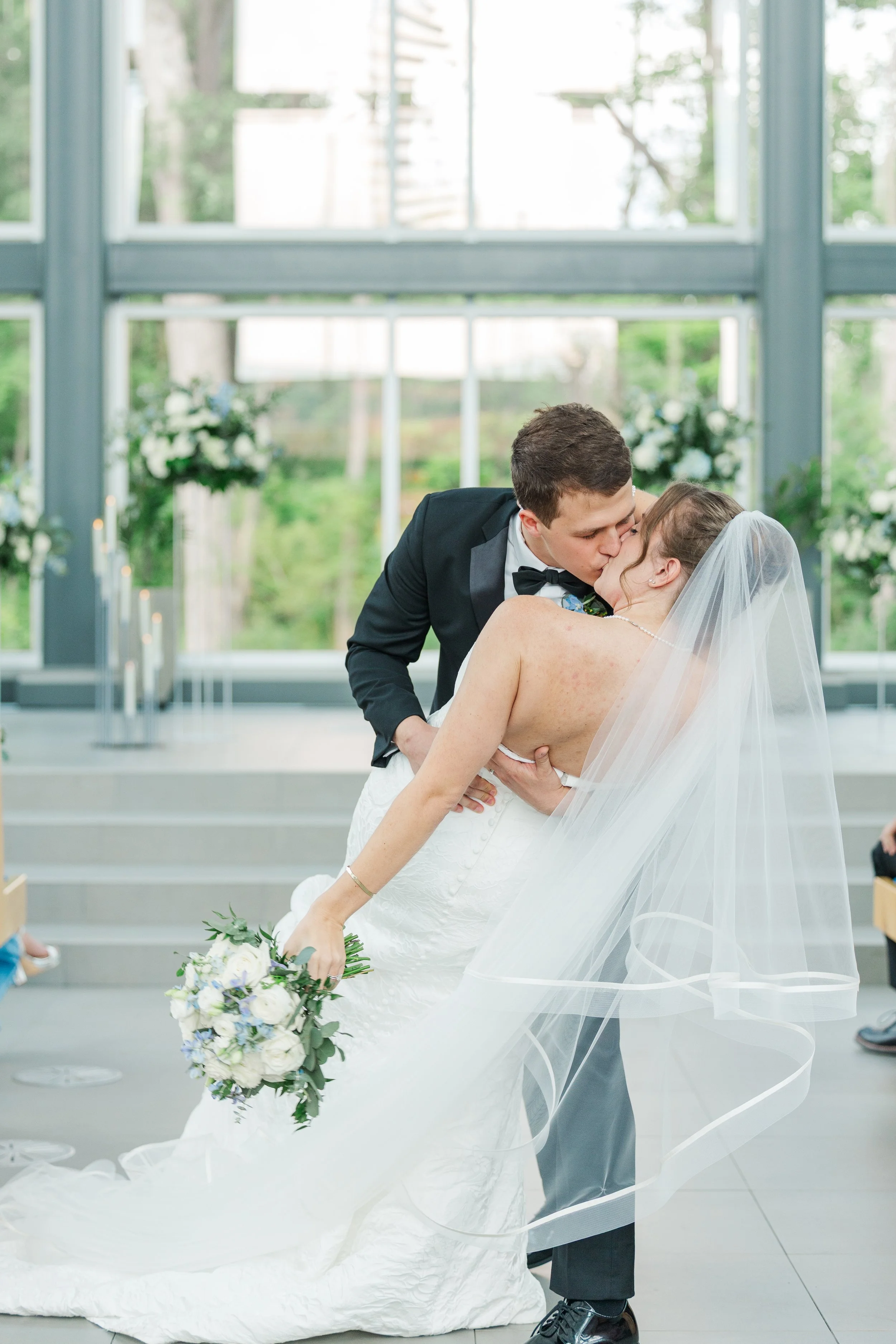 Bride and groom share a joyful first dance inside a light-filled venue at The Mettey in Cincinnati, Ohio. 