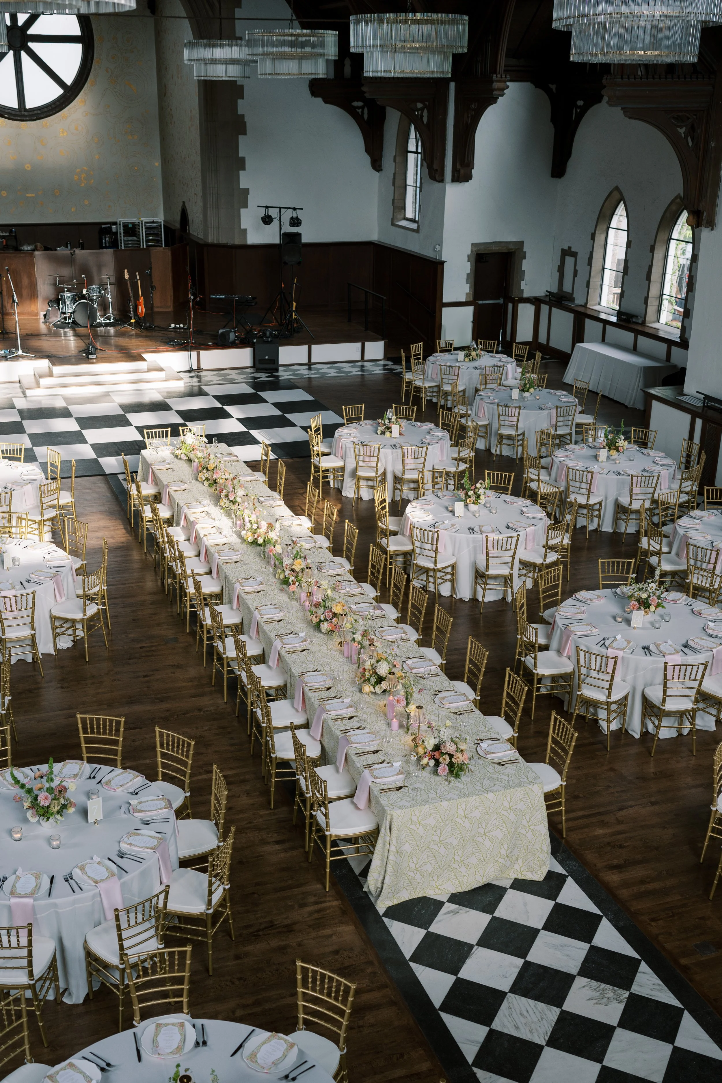 Elegant wedding reception tables with white linens and gold chairs at The Palmoar in Cincinnati, Ohio.