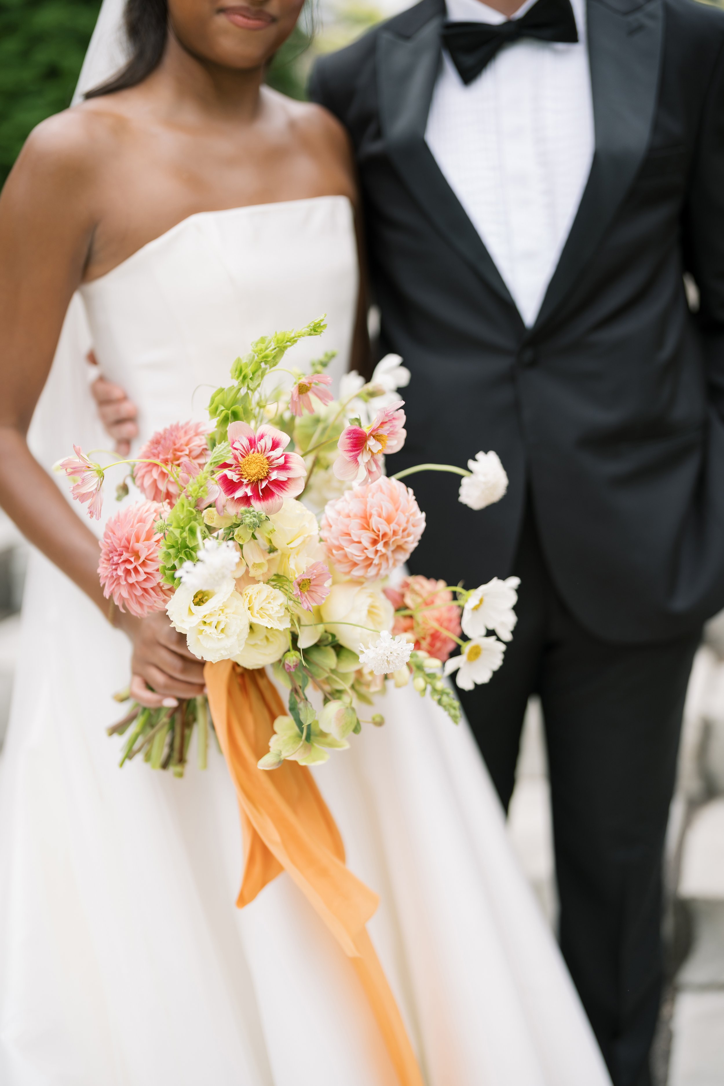 Colorful wedding bouquet with bride and groom at The Palomar in Cincinnati
