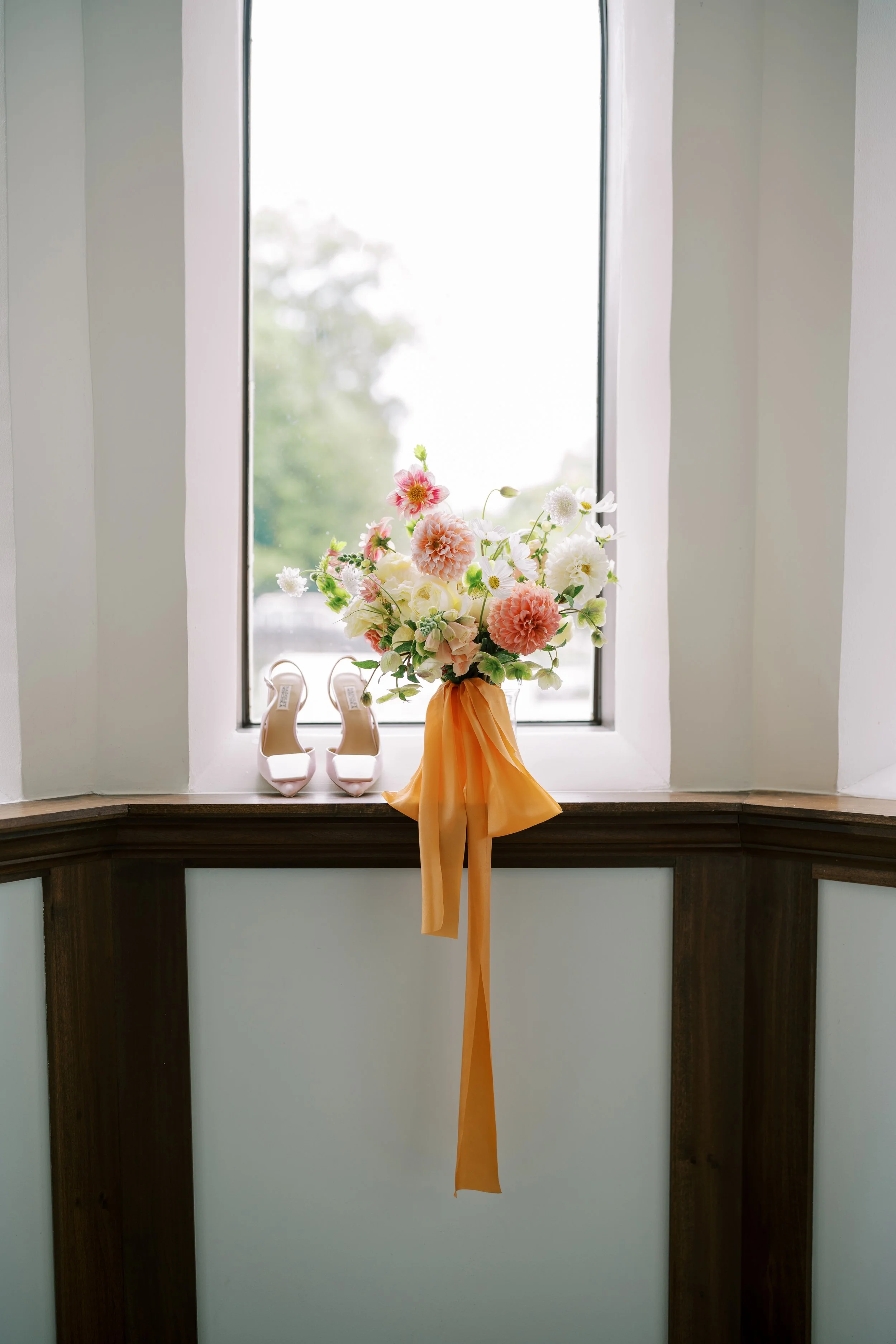 Colorful bridal bouquet with pink, peach and white flowers