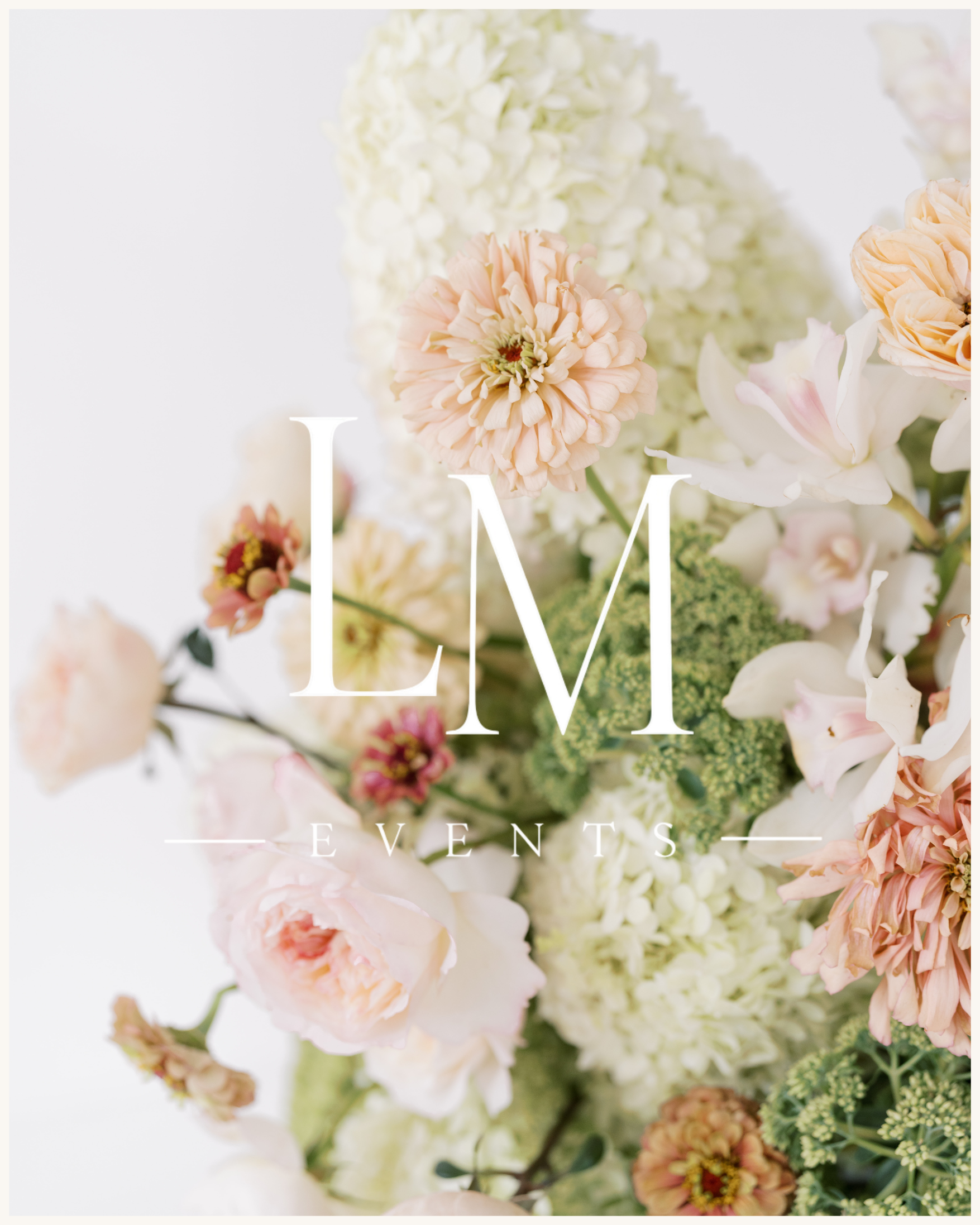 Soft, romantic arrangement of white hydrangeas, blush garden roses, ranunculus, cosmos, and muted peach zinnias styled together in natural light.