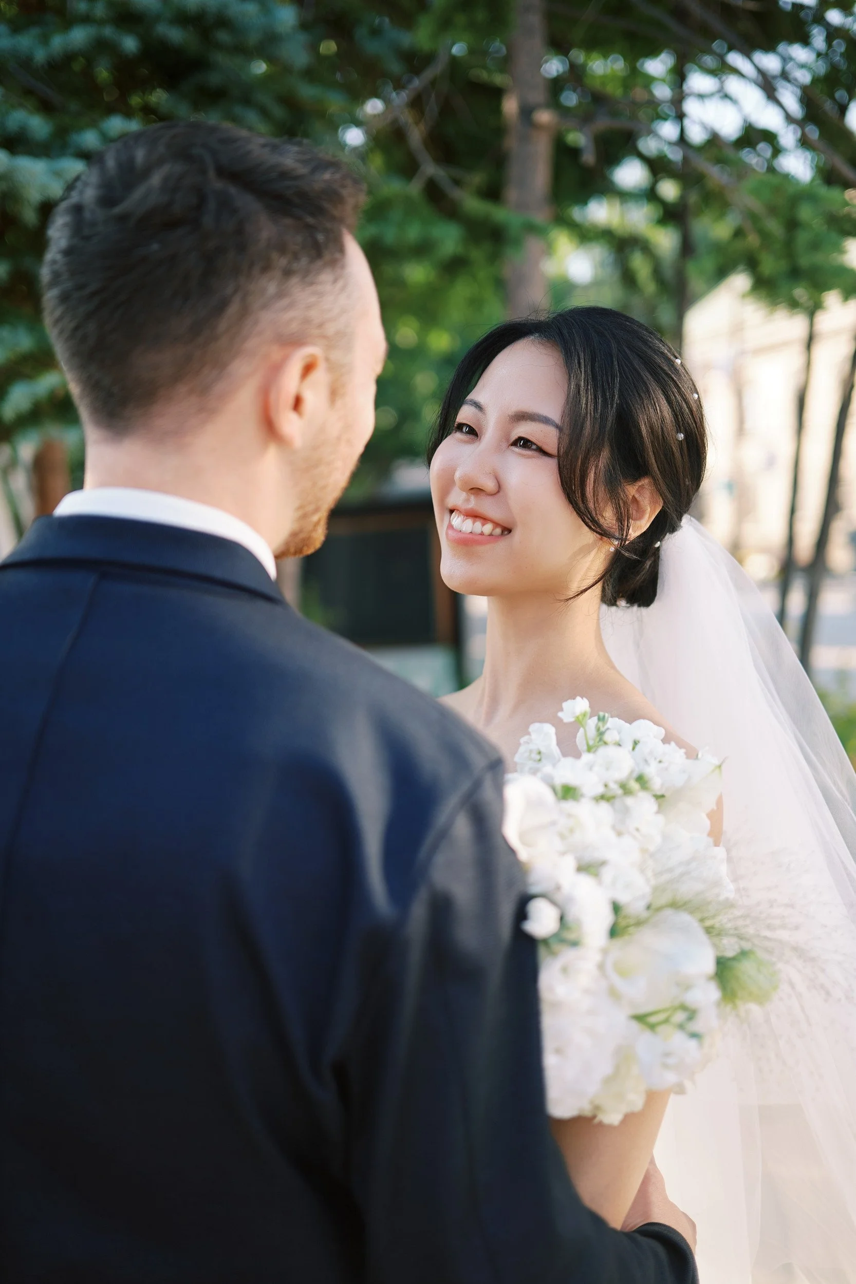 Bride and groom strolling through old town Otaru in the soft light of early summer