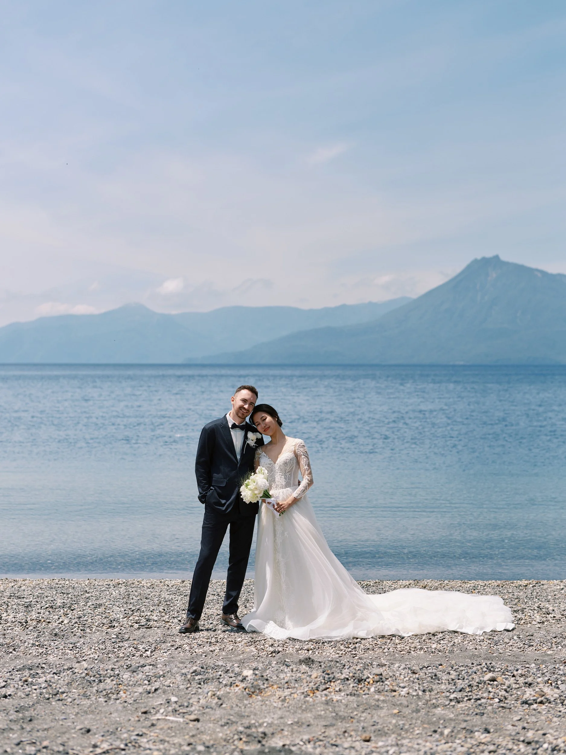 The couple in a quiet moment at the water's edge, Lake Shikotsu, Hokkaido