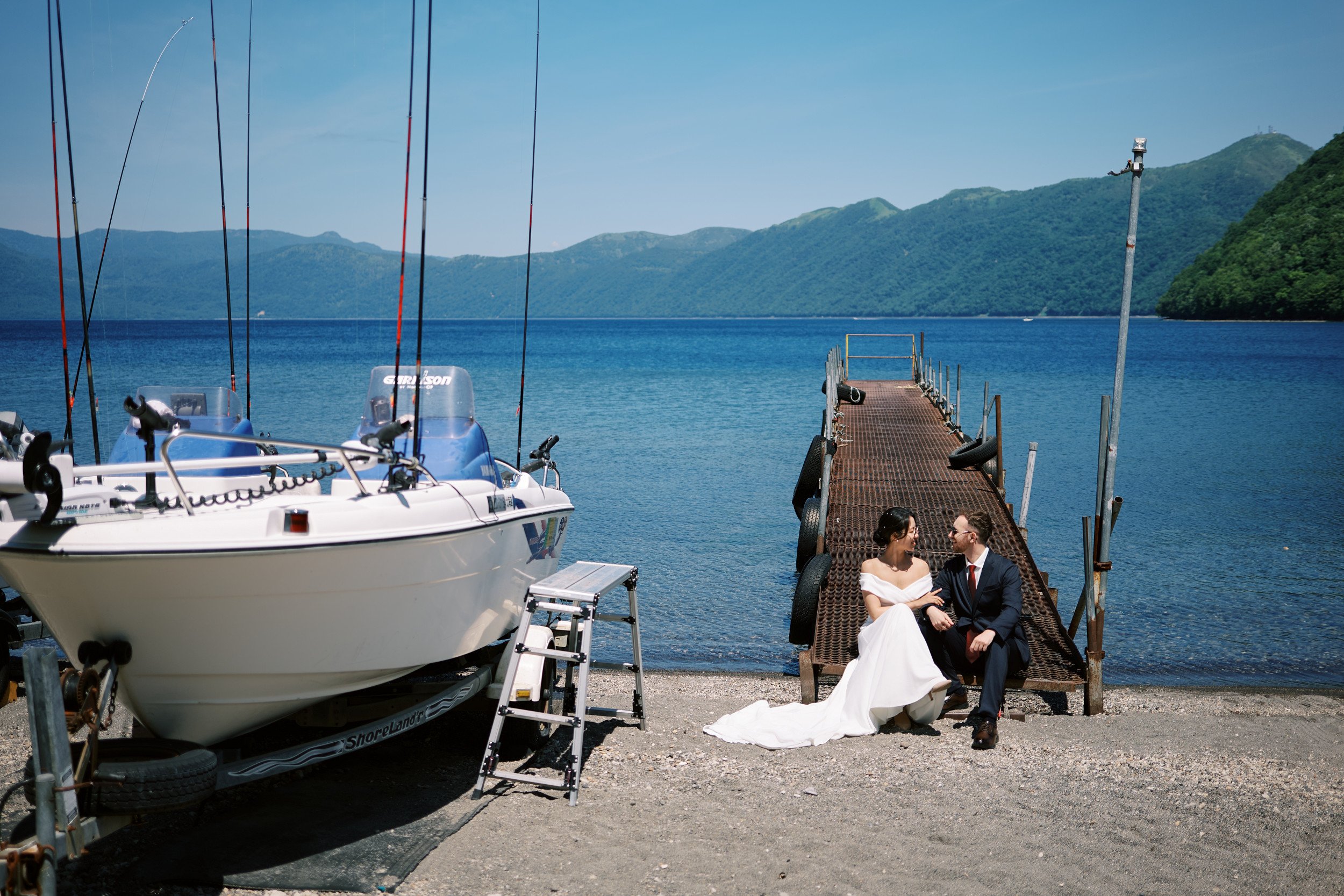 The couple in a quiet moment at the water's edge, Lake Shikotsu, Hokkaido