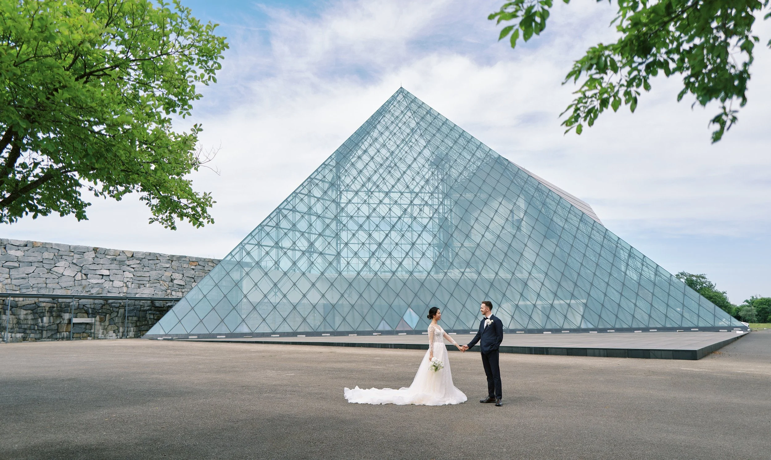 Couple in front of the glass pyramid at Moerenuma Park in Sapporo during afternoon light