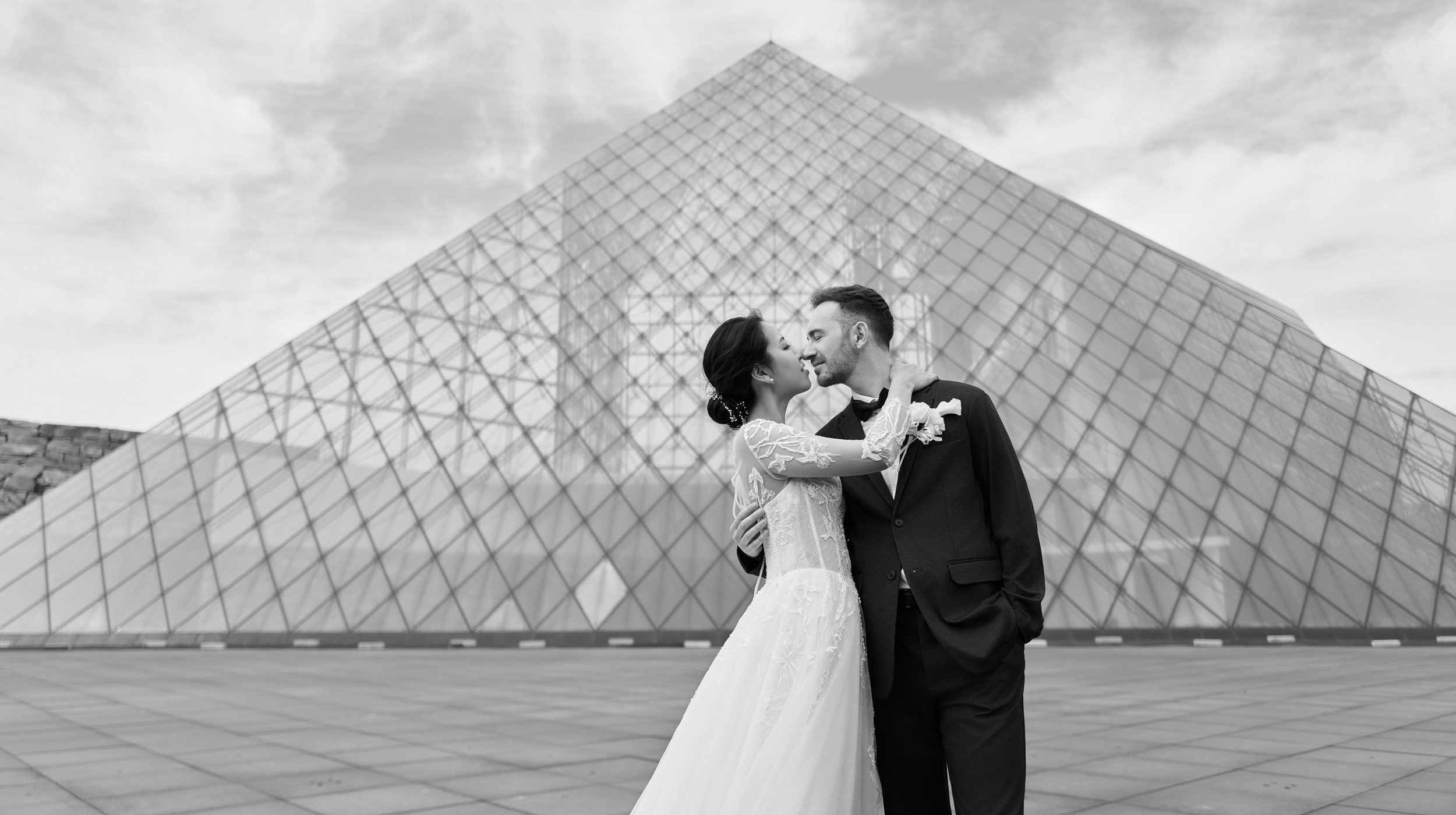 Reflections of the couple in the glass pyramid designed by Isamu Noguchi, Sapporo