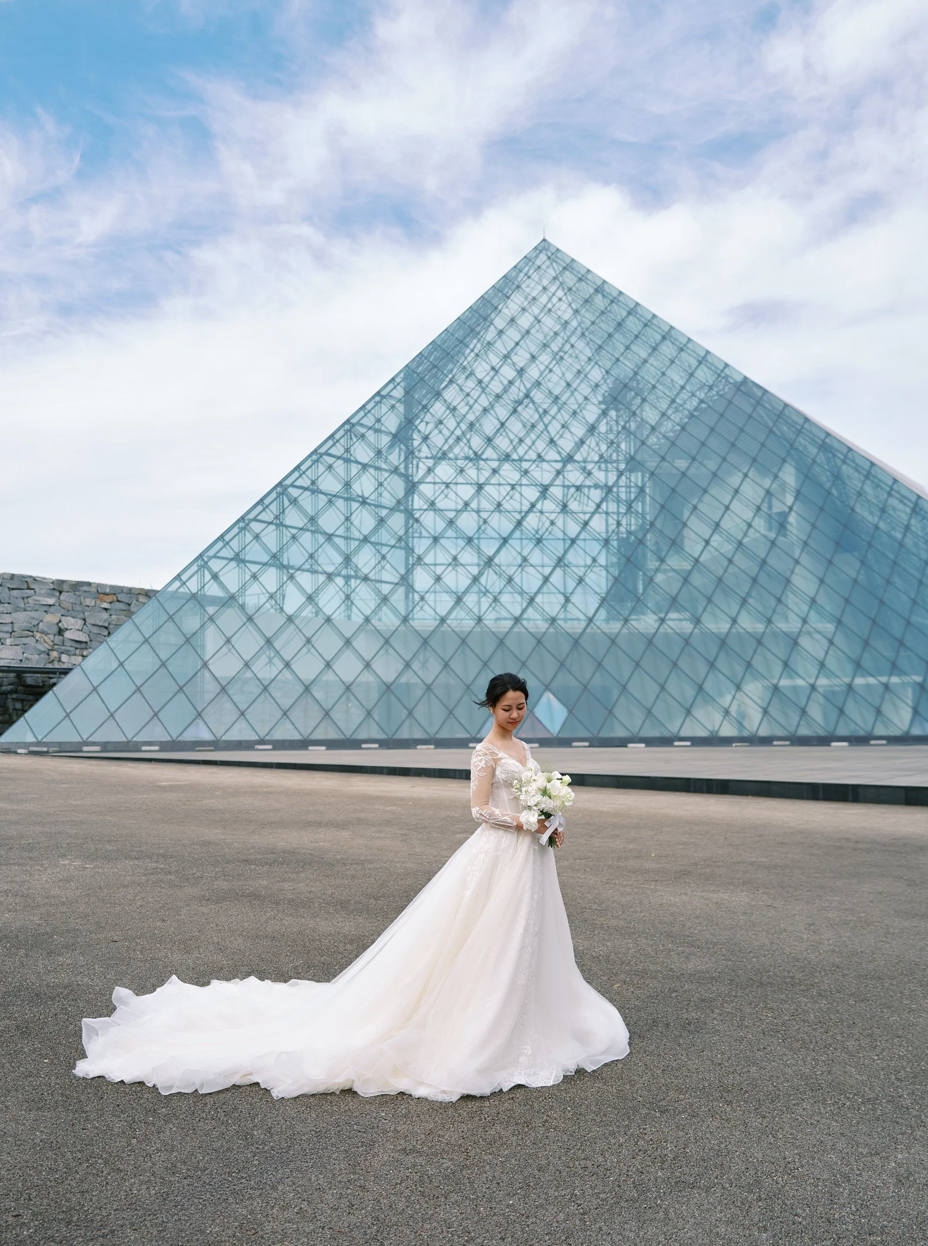 Portrait against the clean lines of the Moerenuma Park glass pyramid