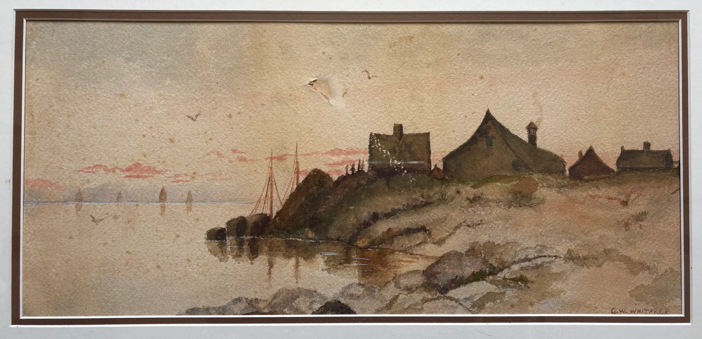 A watercolor painting of a seaside landscape with buildings on a rocky shoreline, sailboats in the water, and a pink and orange sky at sunset.