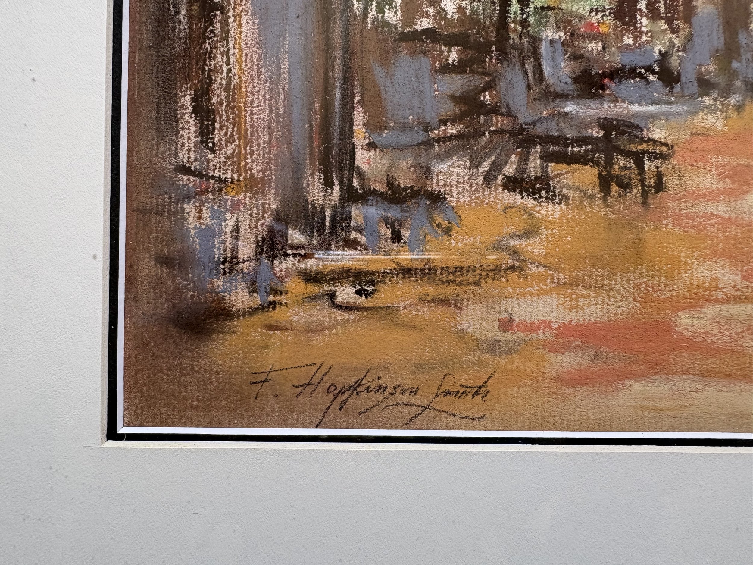 Close-up of a textured paper with handwritten text reading 'F. Hettinson' and a decorative background with brown, yellow, orange, and gray shades.