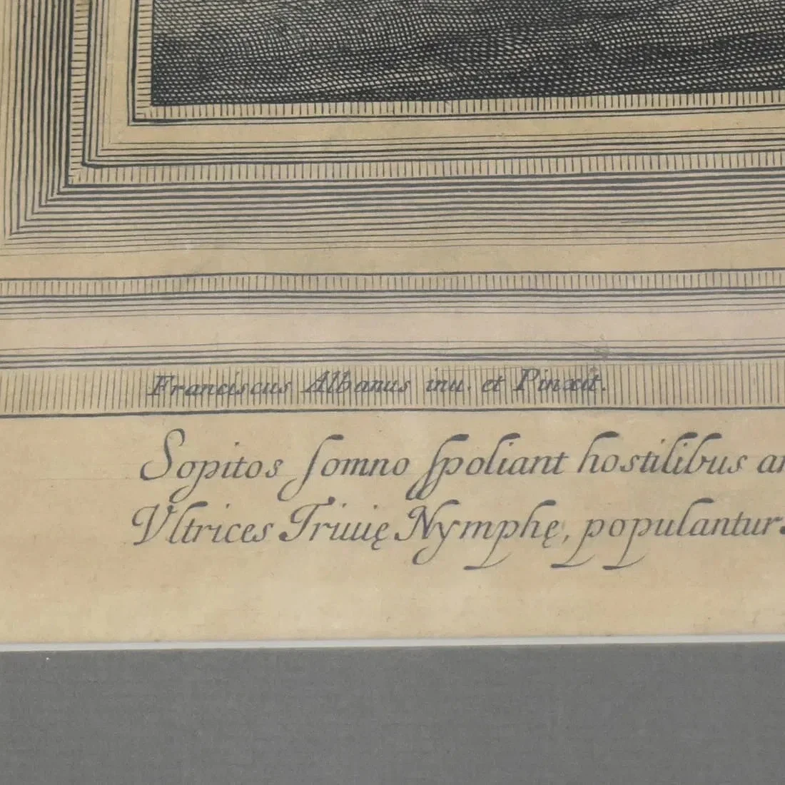 Close-up of a handwritten Latin text on aged paper with decorative borders.