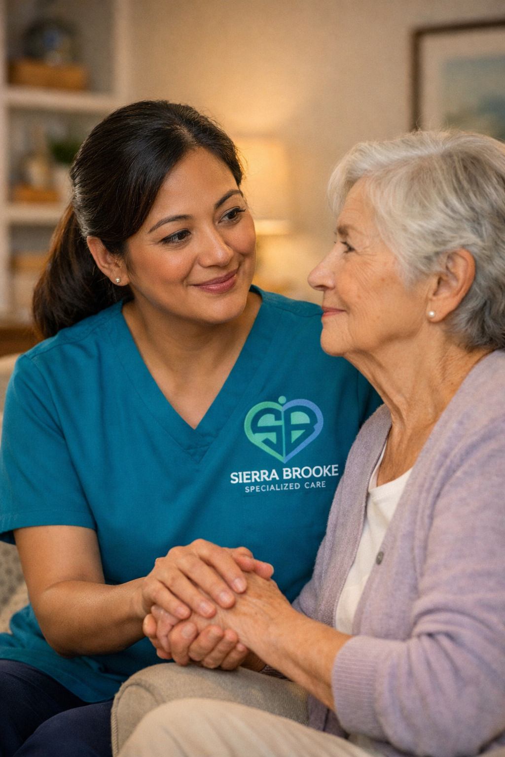 A woman with brown ponytail comforting an elderly woman in a purple cardigan sweater