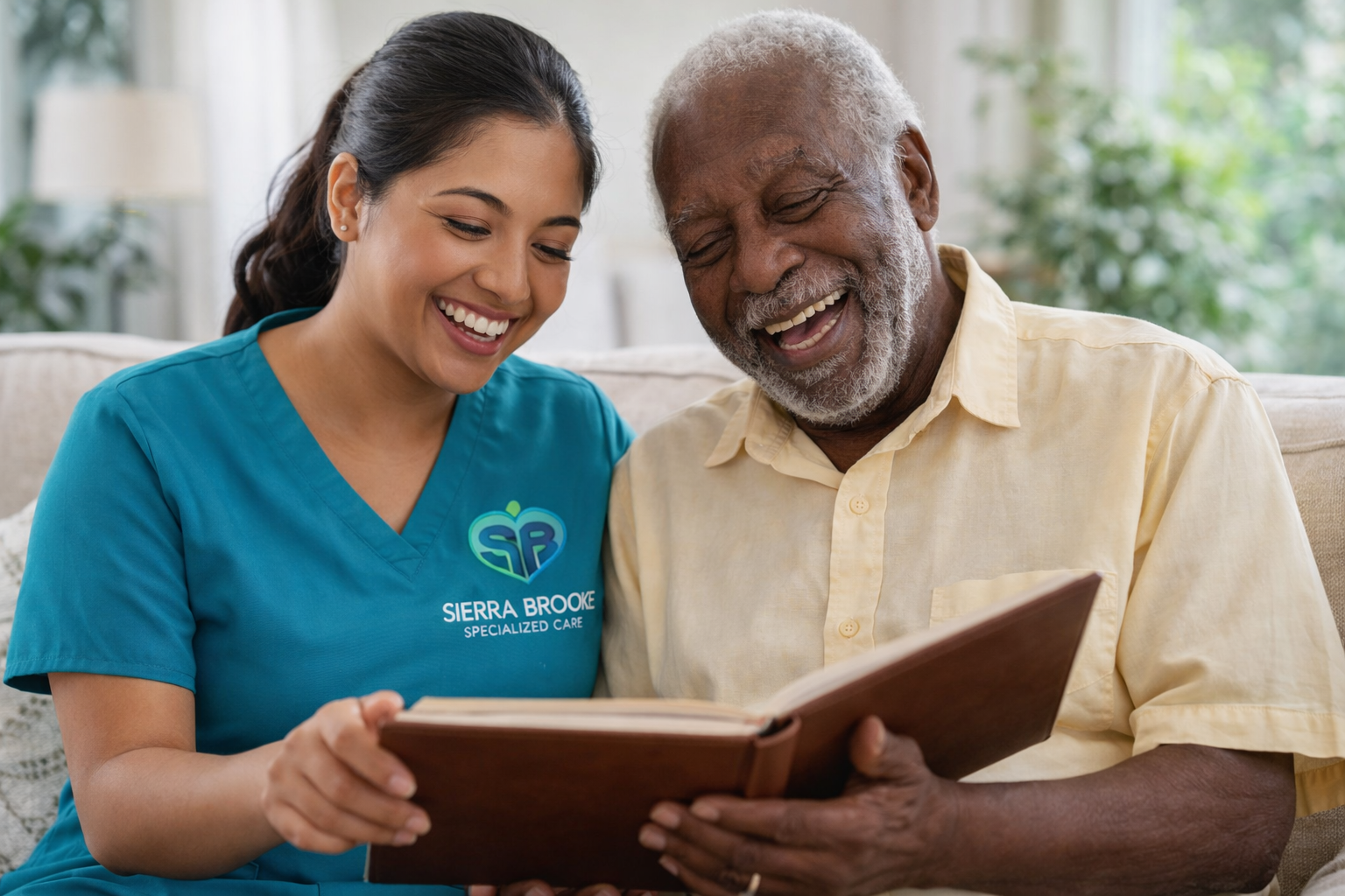 a caregiver looks at a photo album with an elderly man