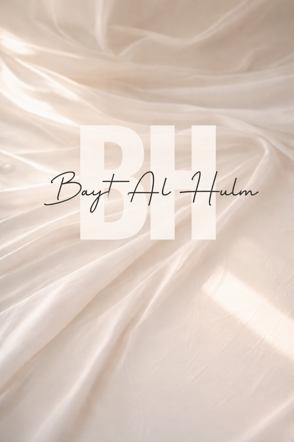 Close-up of cream-colored satin fabric with text overlay 'BI Bayt Al-Hulm' in black cursive font.