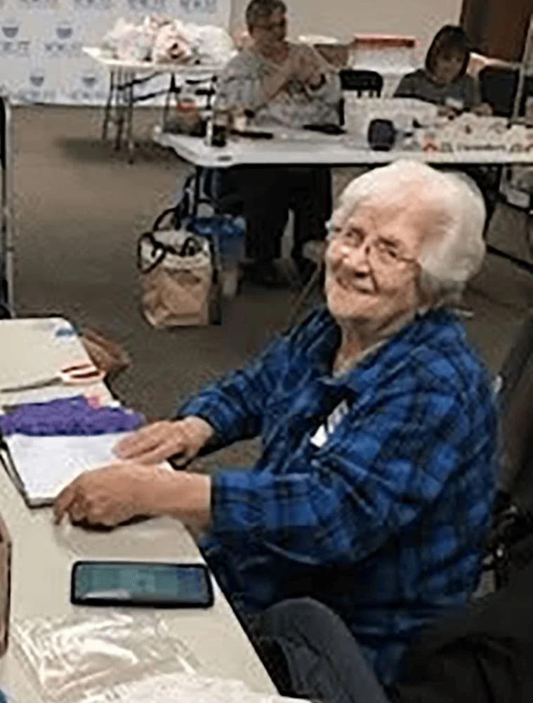 A volunteer sewing projects for needy families.