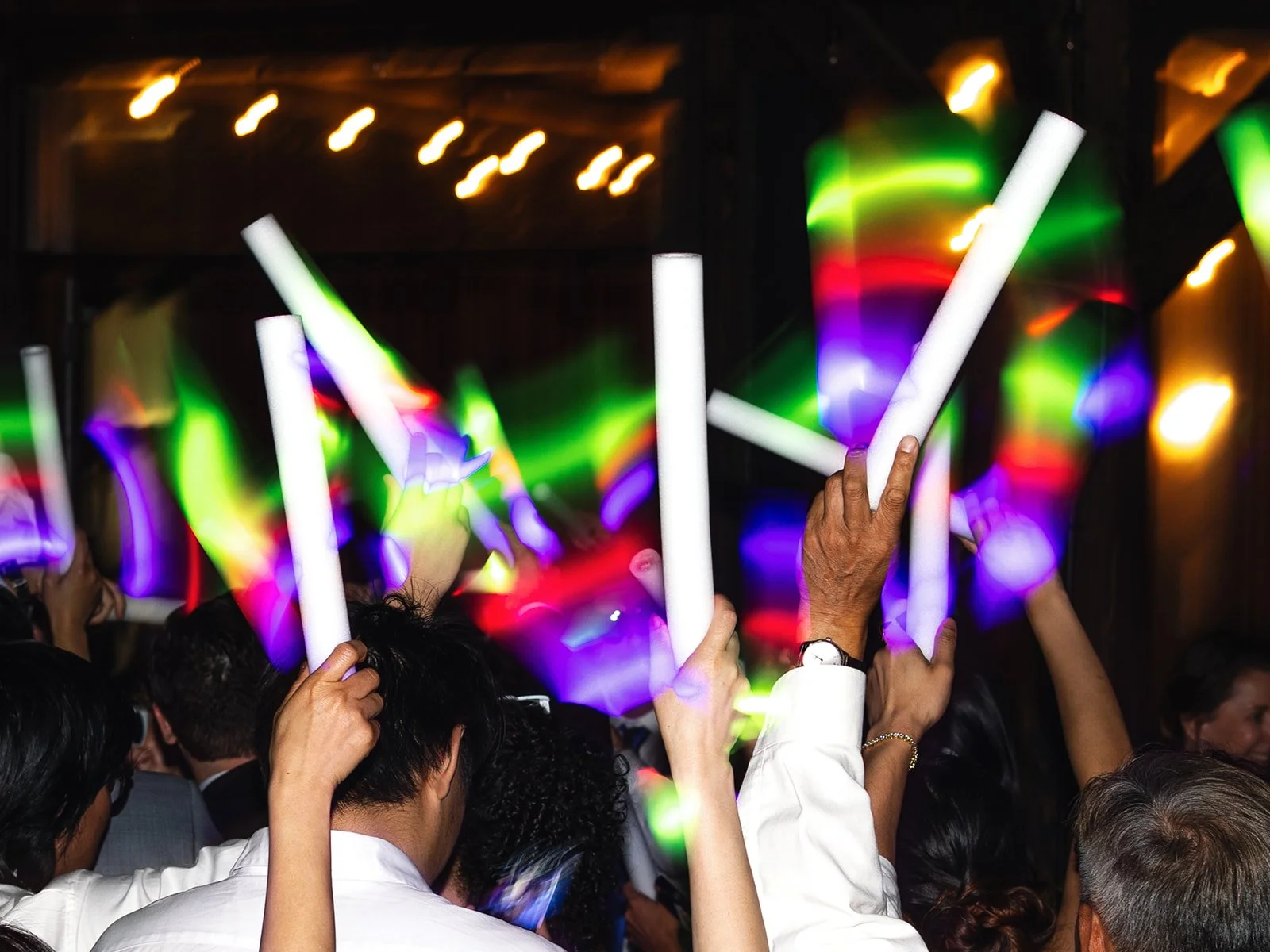 Colorful glow sticks on the dancefloor