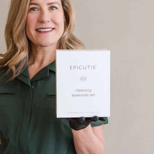Woman smiling and holding a box labeled Epicitus Cleansing Essentials Set.