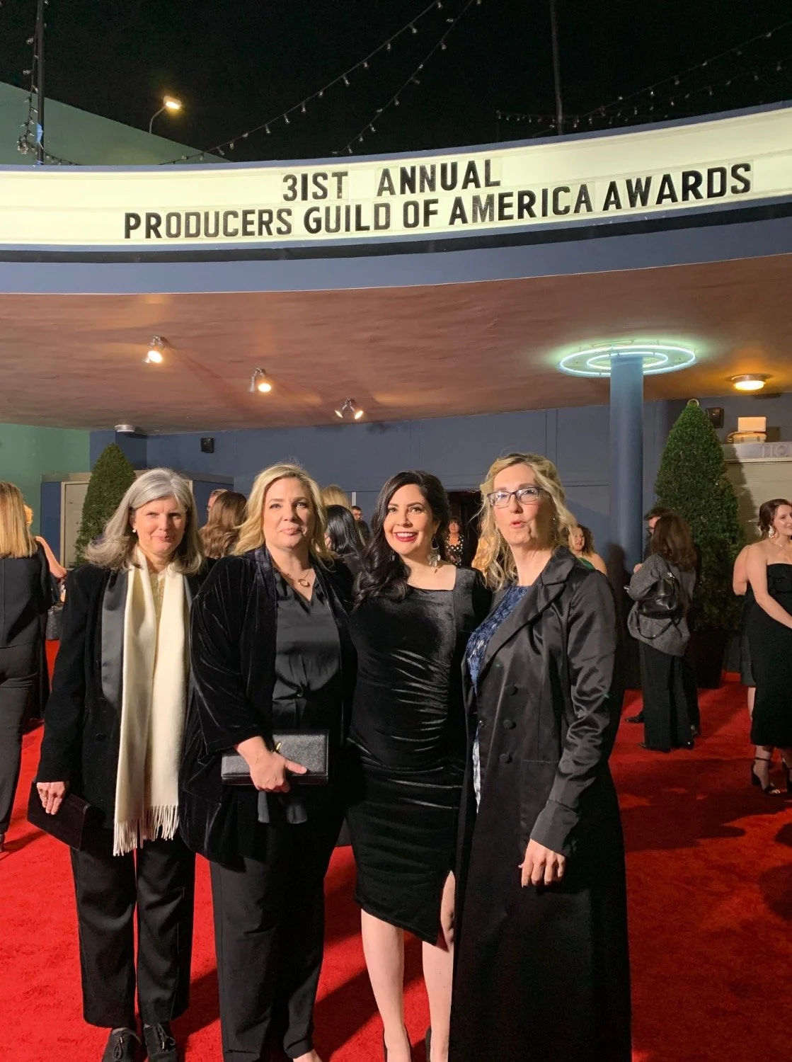 Laura Hoeppner at the 31st Annual Producers Guild of America Awards, with a marquee sign in the background.