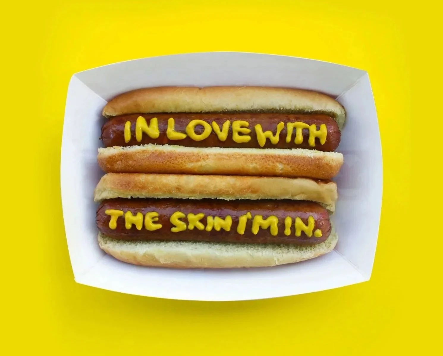 photo of hot dog with mustard text that reads in love with the skin I'm in