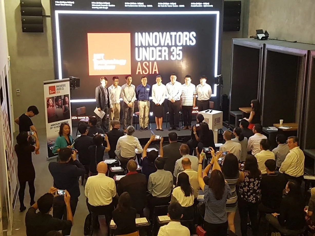 For Koelnmesse, Pinpoint PR organised media attendance at MIT Technology Review's EmTech Asia Innovators Under 35 Awards ceremony. A group of people on stage at the 'Innovators Under 35 Asia' event, with an audience seated and taking photos of them.