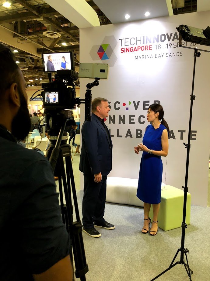 An exhibitor being interviewed by a Pinpoint PR journalist at a tech conference by IPI, called TechInnovation, held at Marina Bay Sands.