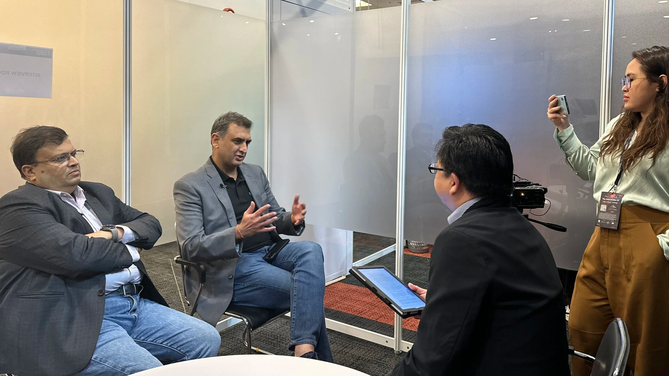 UNO Digital Bank CEO Manish Bhai talks to an Asian Banking publication editor and photo journalist. UNO Digital Bank's Chairman Kalidas Ghose is beside him.