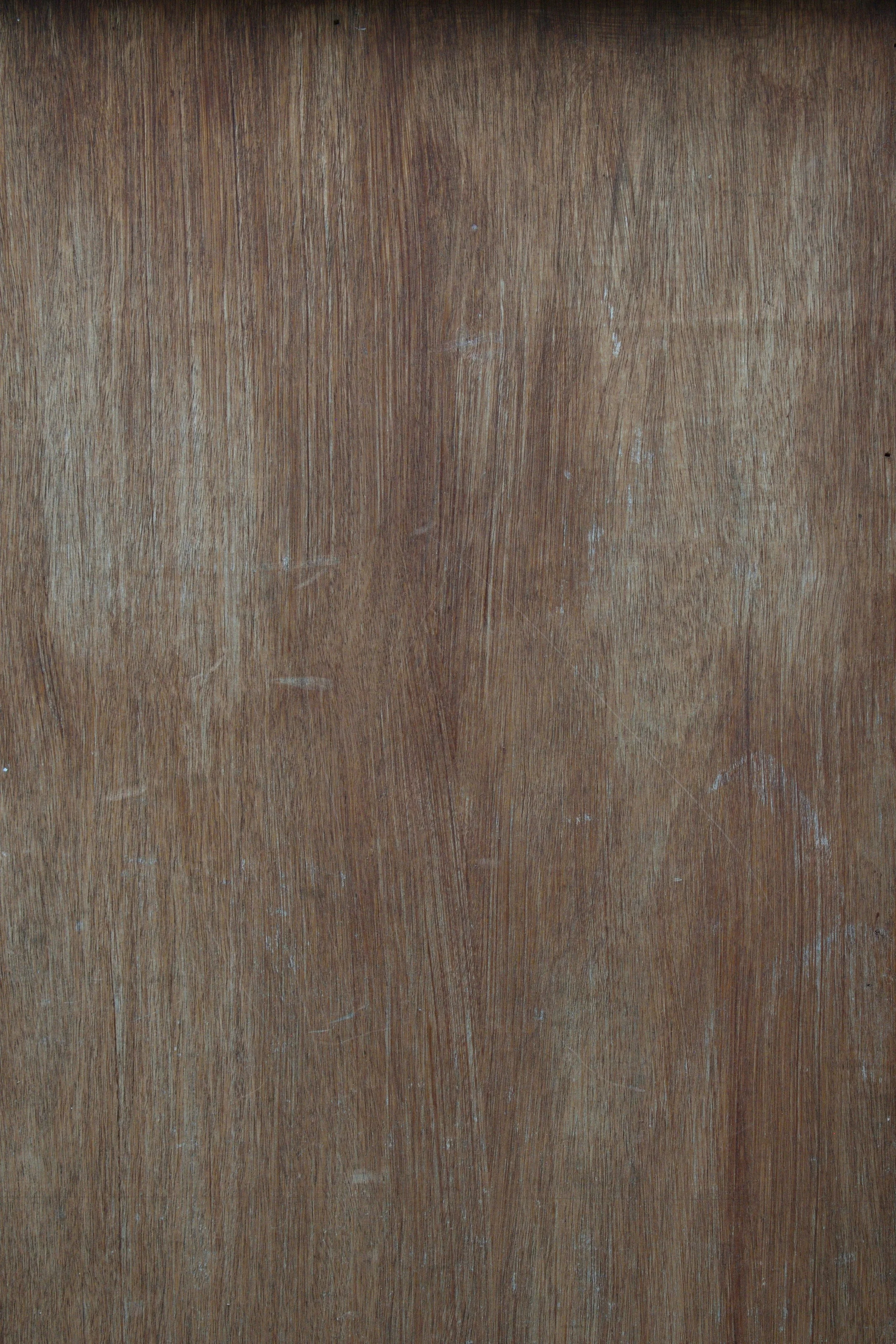 Close-up of a wooden surface with visible grain and scratches.