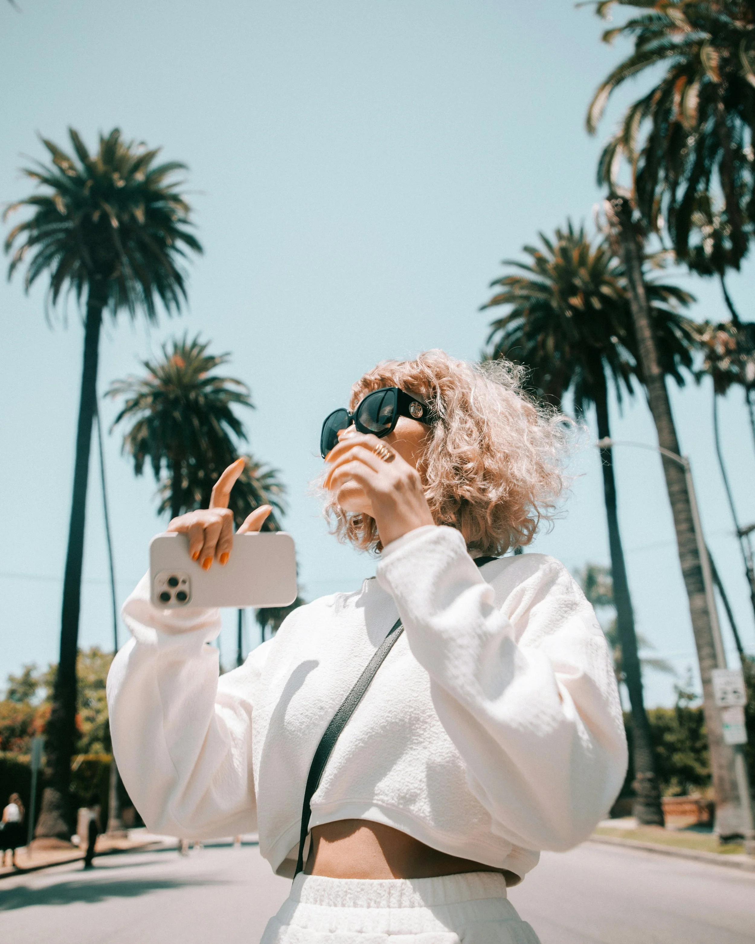 Girl smiling by palm trees after therapy in los angeles, ca