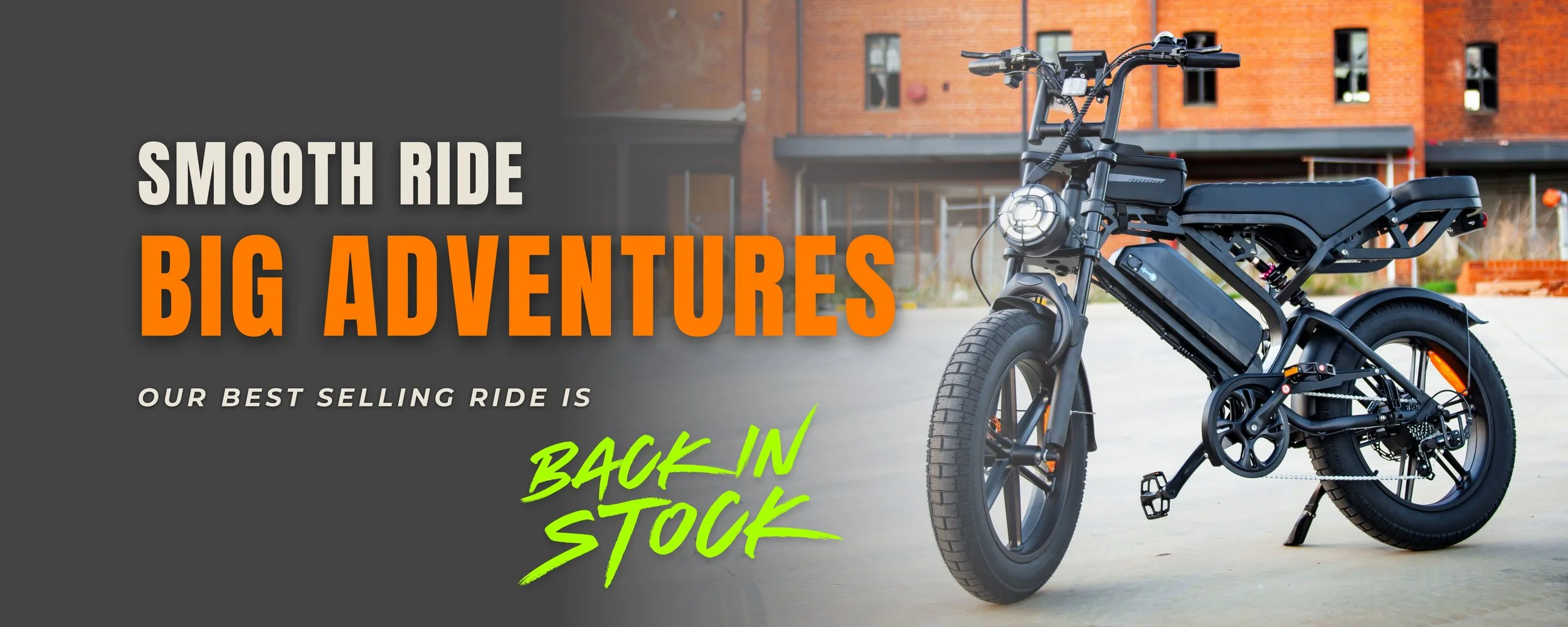 An electric motorcycle parked outdoors in front of a brick building, with a text overlay promoting smooth ride, big adventures, and back in stock.