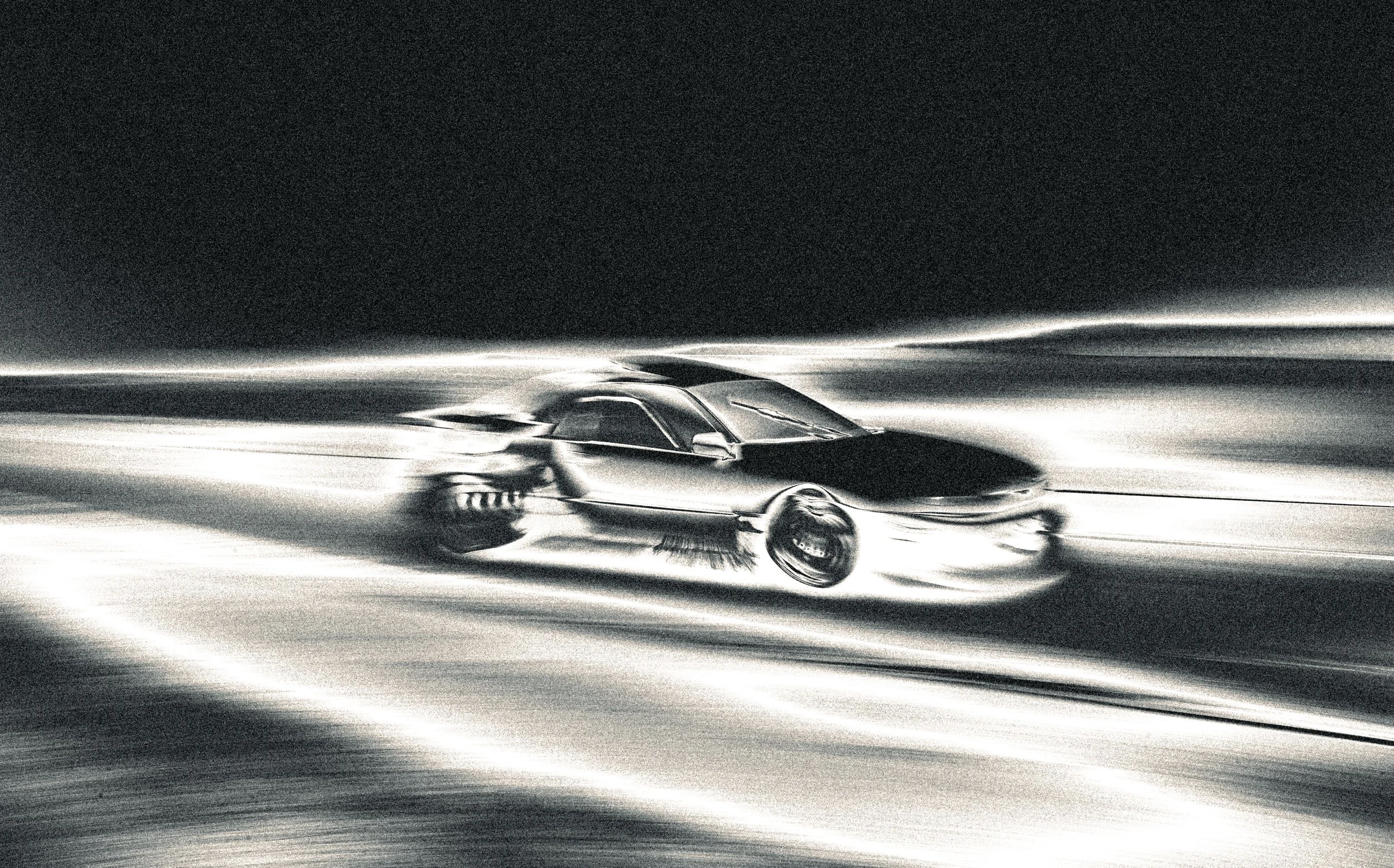 A sleek, black sports car speeding on a dark road at night, with the background blurred to emphasize motion.