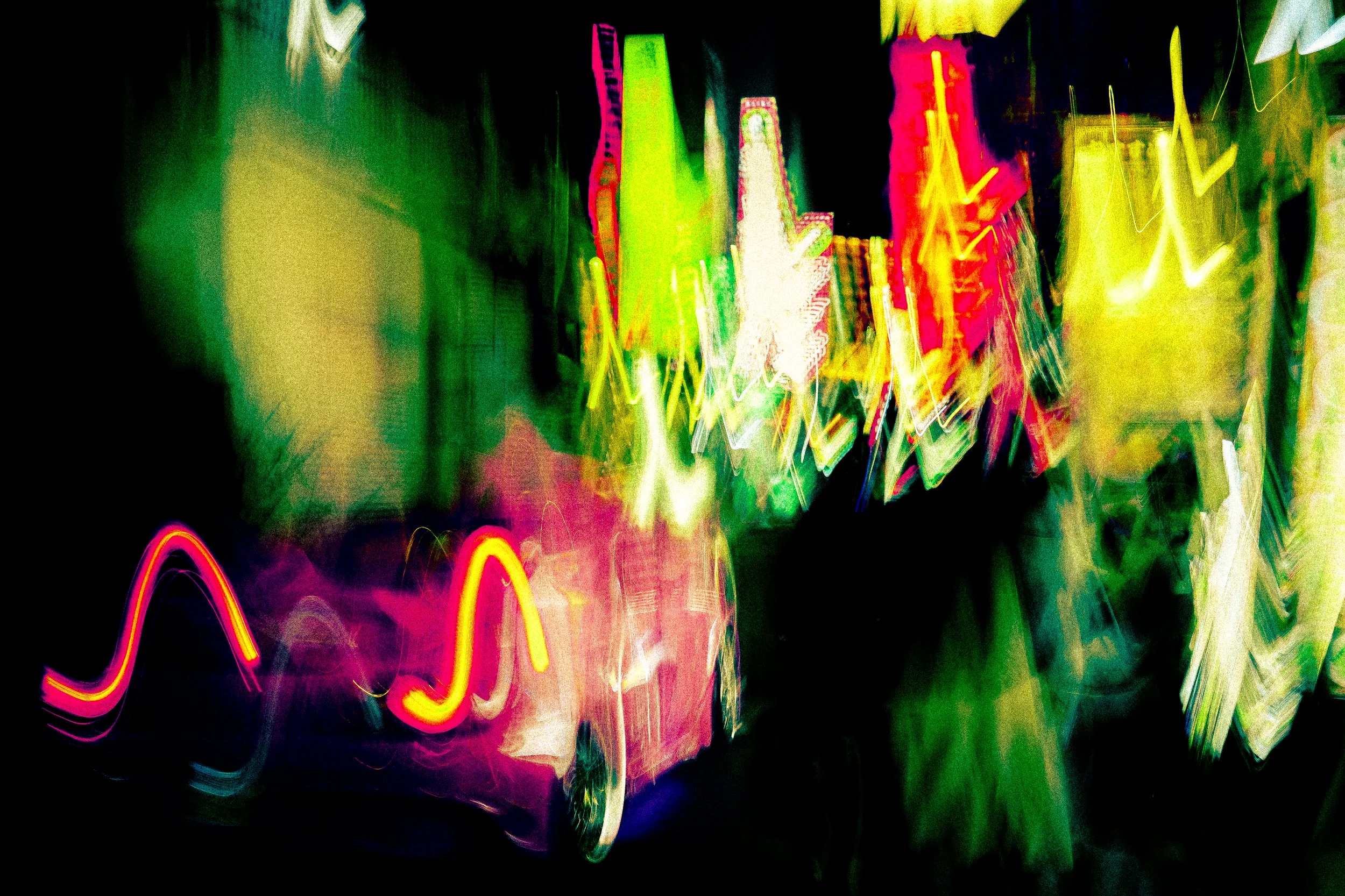 Abstract colorful neon light streaks against a black background, creating a vibrant and dynamic pattern.