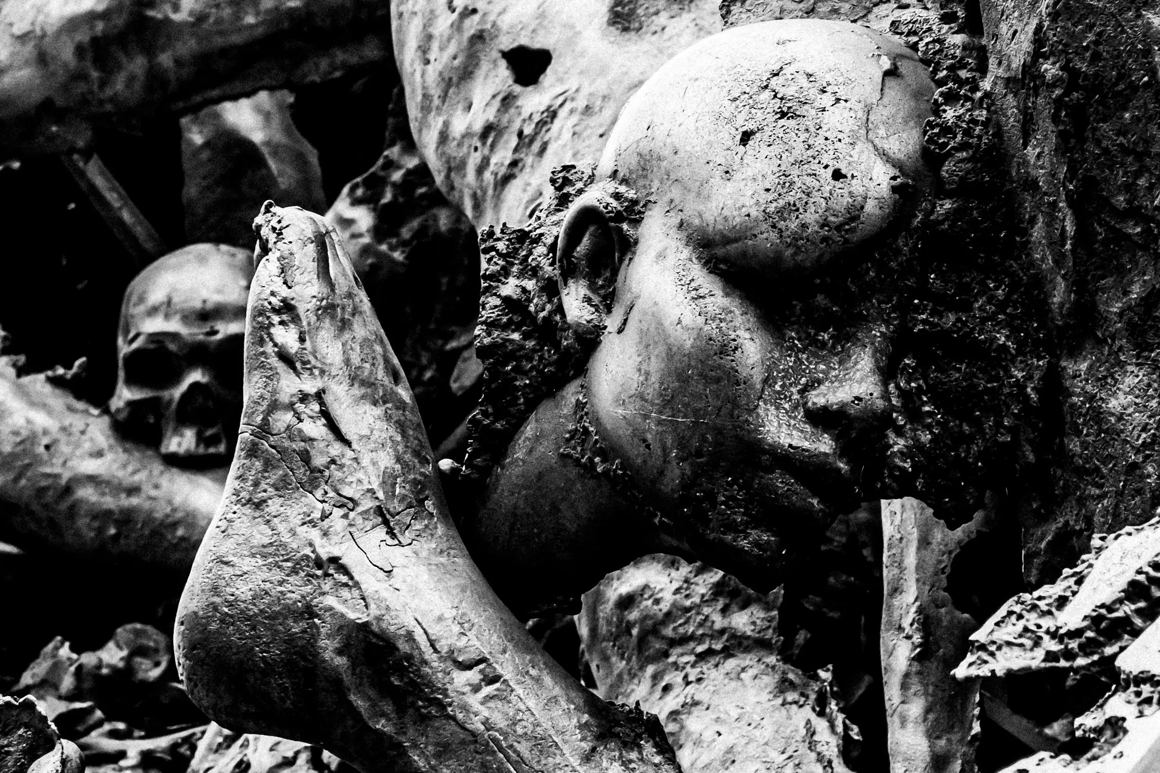 A pile of dirt and rocks with a crushed skull and bones visible among the debris.