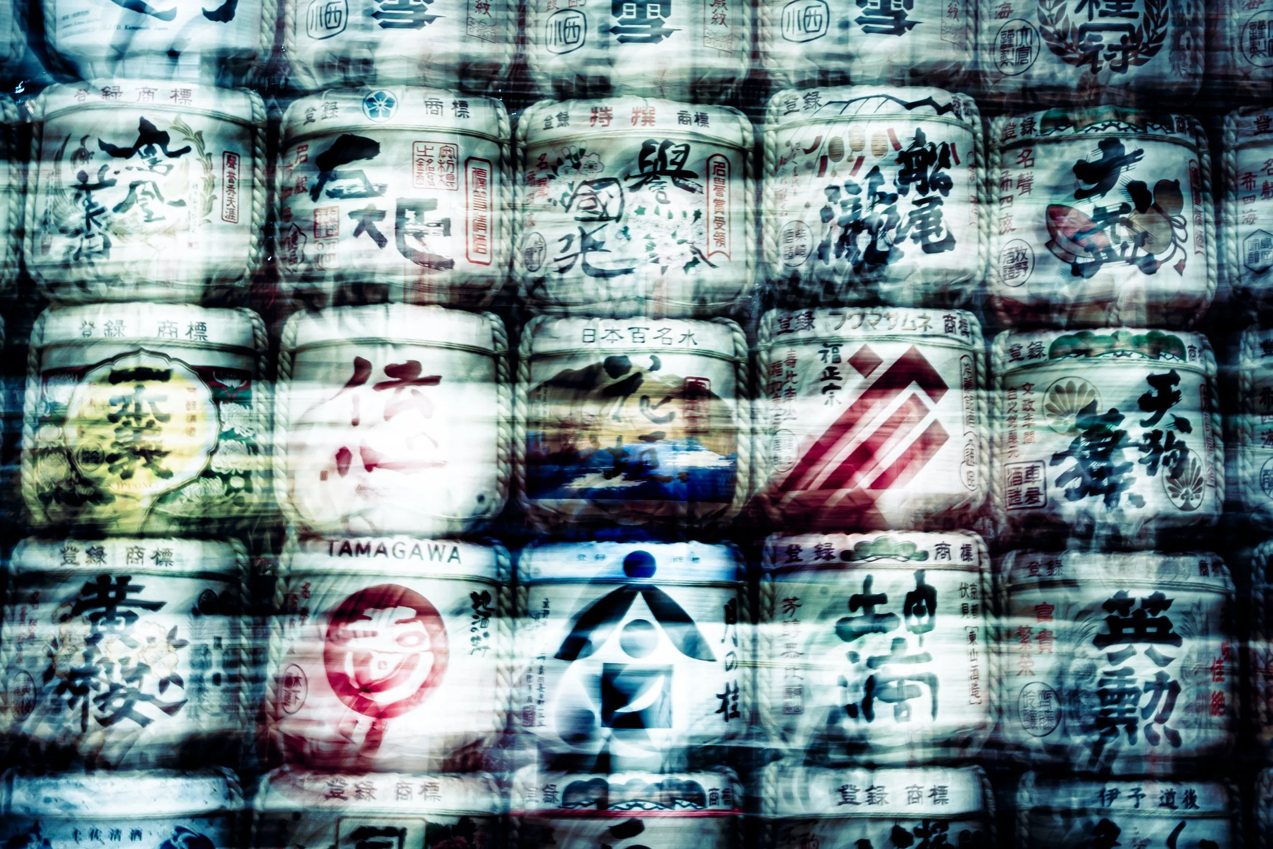 Close-up image of traditional Japanese paper lanterns decorated with Japanese characters, symbols, and illustrations.