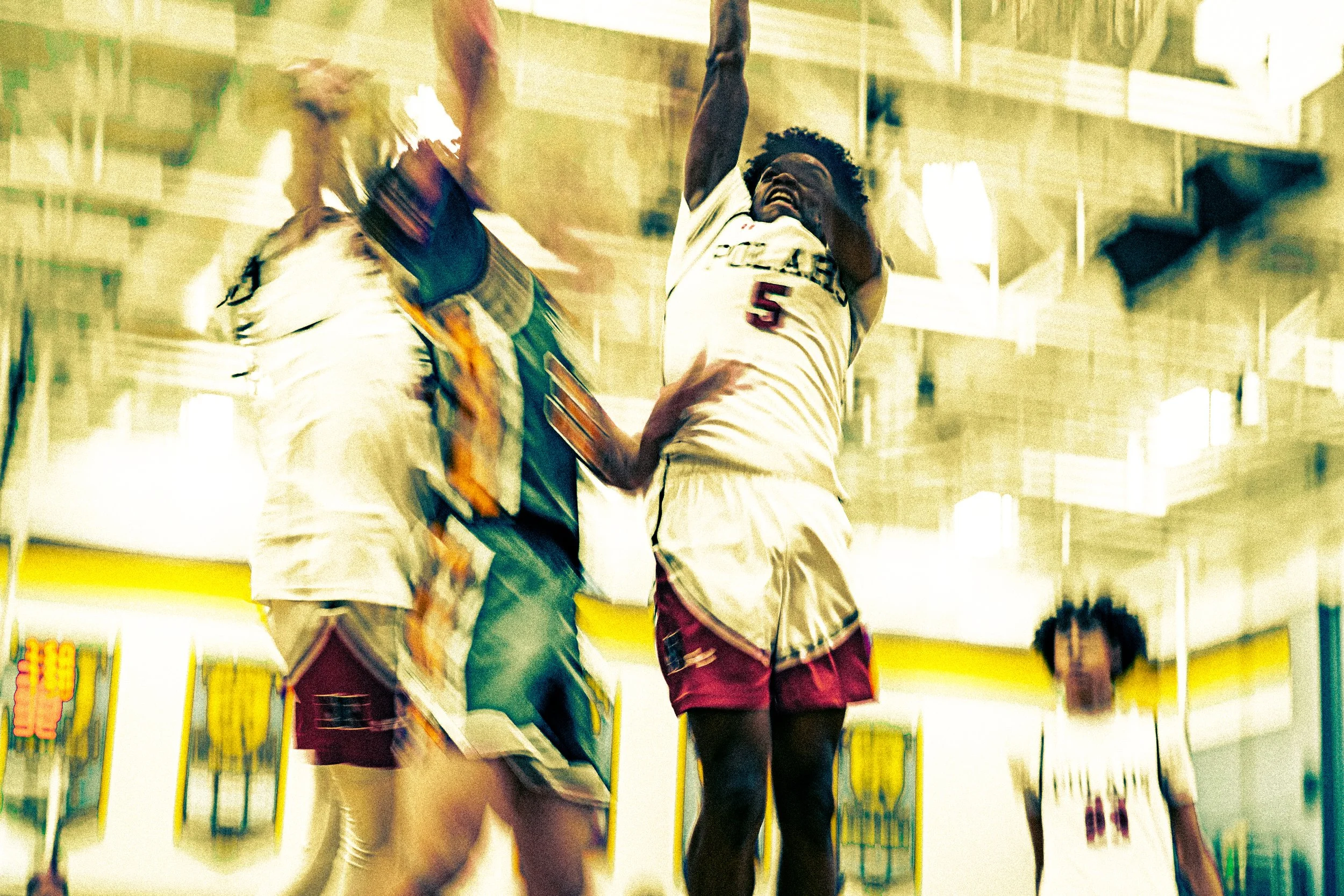 Two basketball players in a gym, one jumping to block the other, with a mirror reflecting their actions.