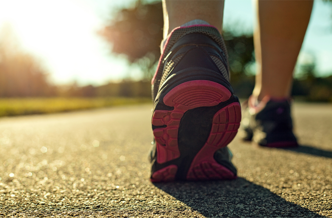 A pair of comfortable walking shoes set by a doorway, ready for an early morning walk.